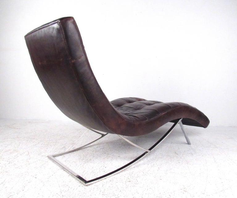This stylish modern chaise longue chair features tufted brown leather with a distressed patina situated on a chrome base. Comfortable lounge design makes this an excellent seating option for home or office, please confirm item location (NY or NJ).