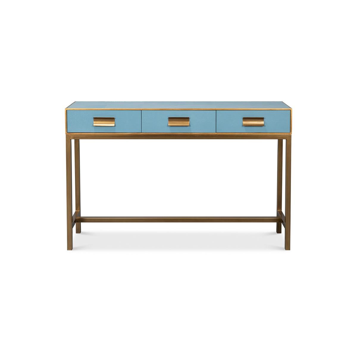 This piece, beautifully crafted with a luxurious leather exterior in a serene chambray blue, is accentuated with delicate gilt trim, adding a hint of glamour to its modern design. The console measures 54