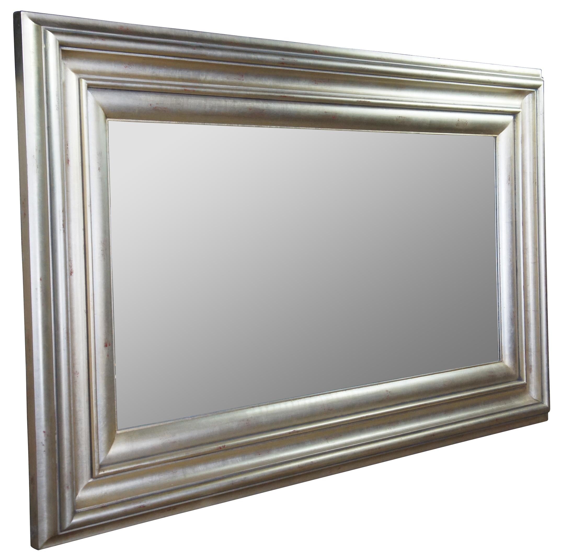 Oversized modern wall mirror. Great for user over a mantel/ along a wall. Black and gold mottled finish with beveled glass. Measures: 52