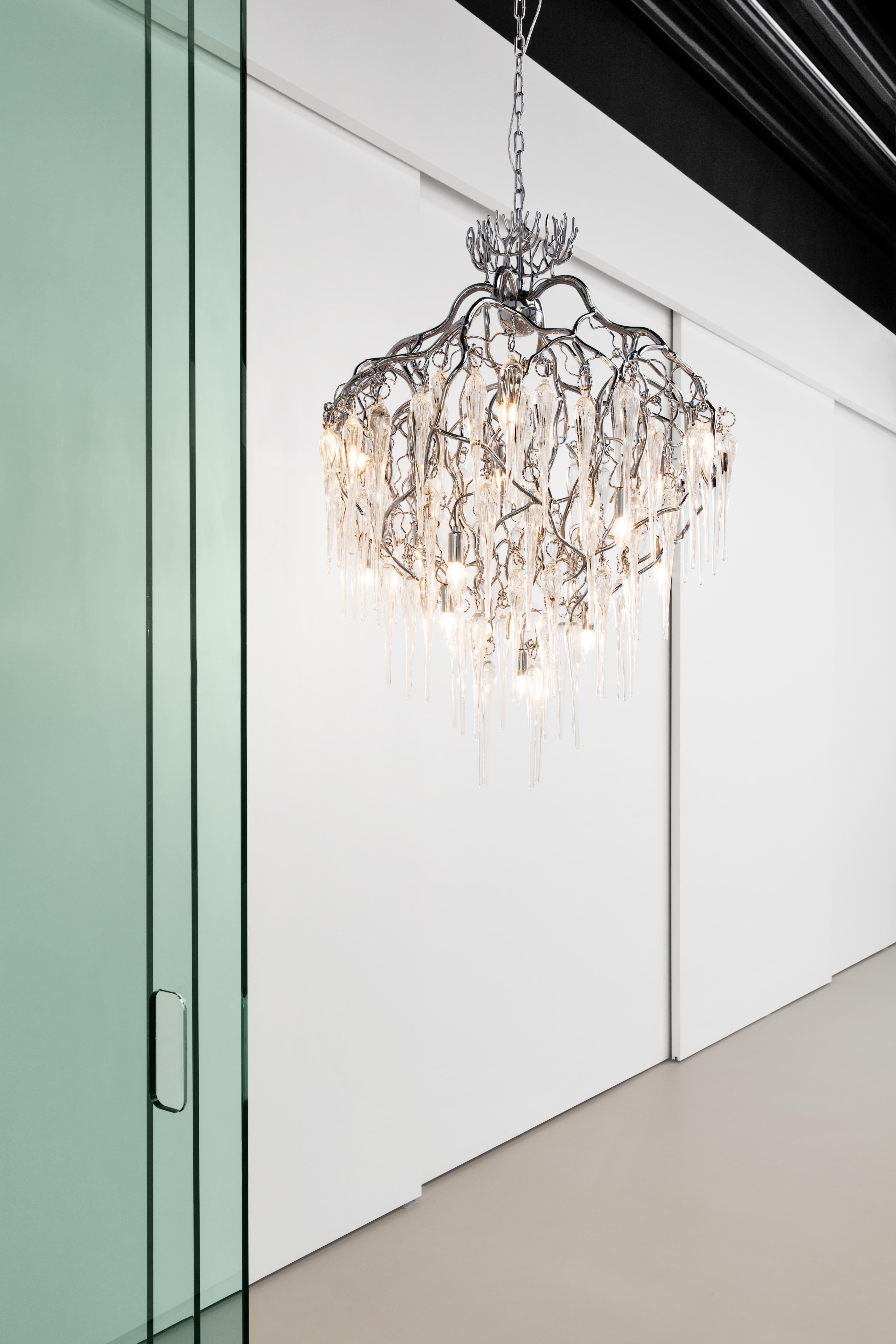 This modern chandelier in a nickel finish is dressed with mouthblown glass icicles, crafted in our own atelier. The Hollywood Icicles collection is designed by William Brand, founder of Brand van Egmond.

In the sheltered heart of a tree, when the