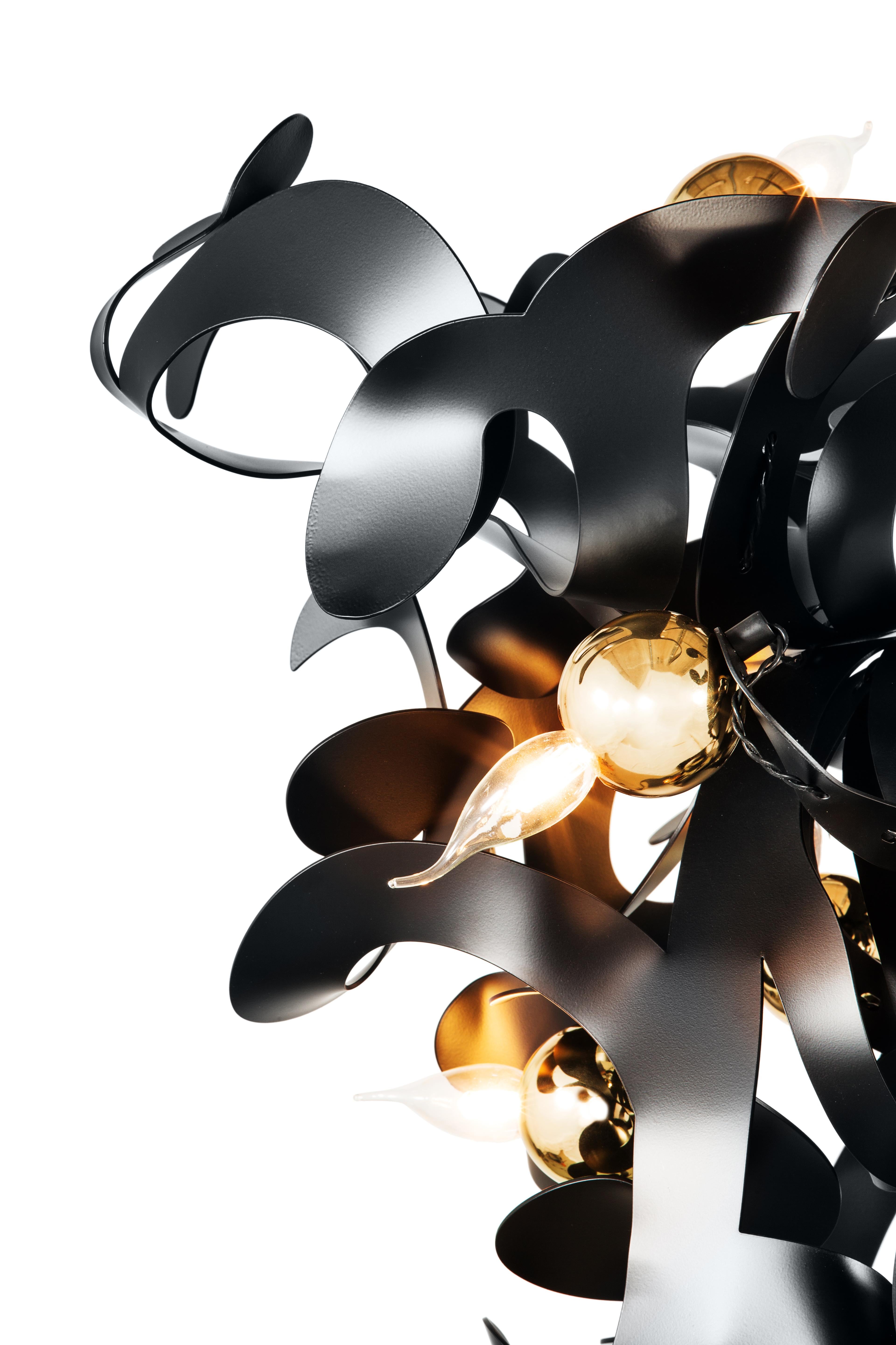 Designed by William Brand, this Kelp modern chandelier in a conical shape and in a black matt finish is bent by skilled craftsmen in graceful curls and shapes in the atelier of Brand van Egmond. The playful and organic form of the Kelp offers