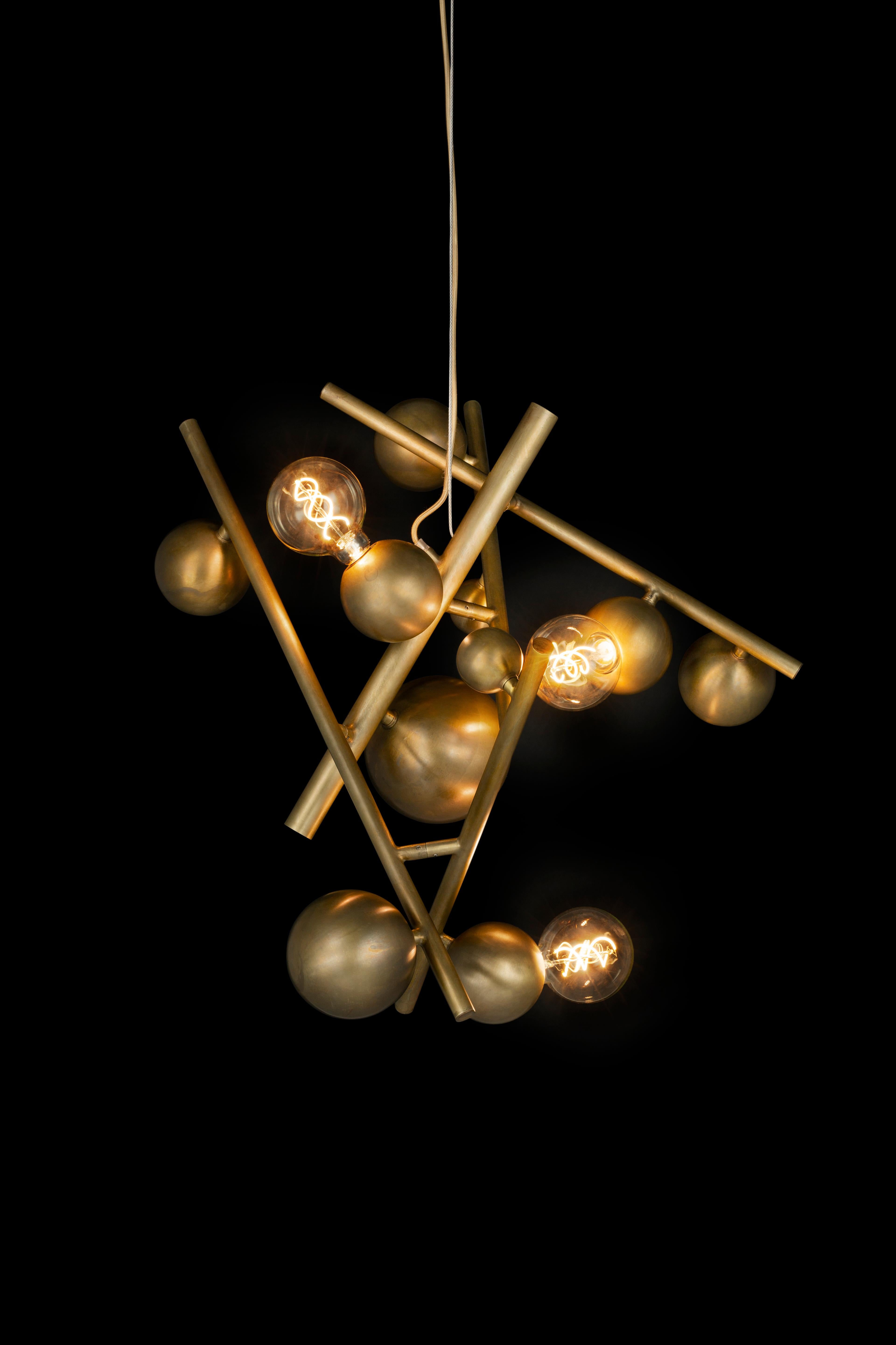 The Galaxy, a modern chandelier in a brass burnished finish, is designed by William Brand, founder of Brand van Egmond. Sculptural and full of character, the chandelier is available in two sizes, with and without downlights, in the finishes black