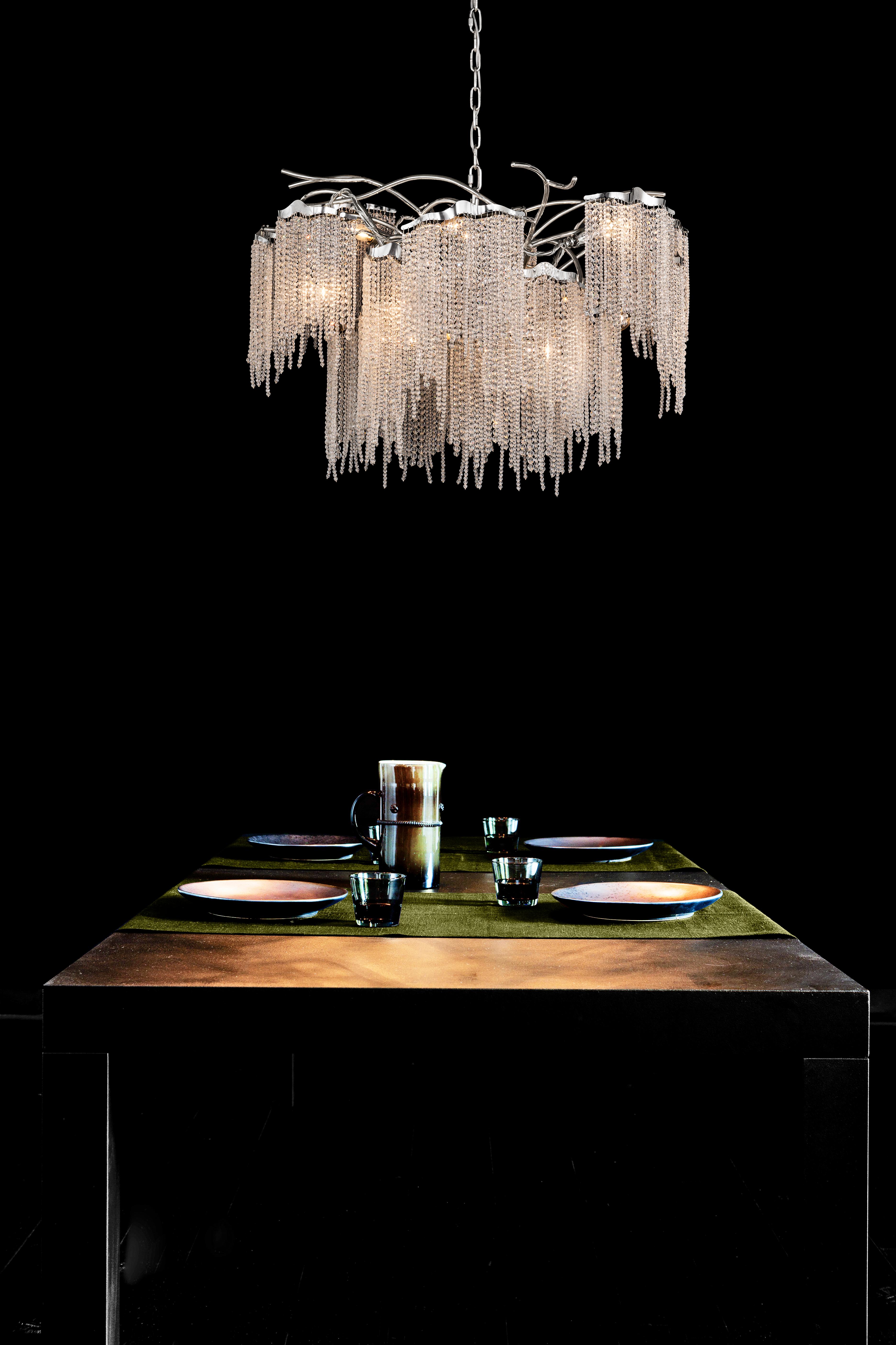 This modern chandelier in a round shape and in a nickel finish with crystals, is part of the Victoria collection, designed by William Brand of Brand van Egmond.

Before you see it, the sparkling light reaches your eyes in full splendour. The fresh