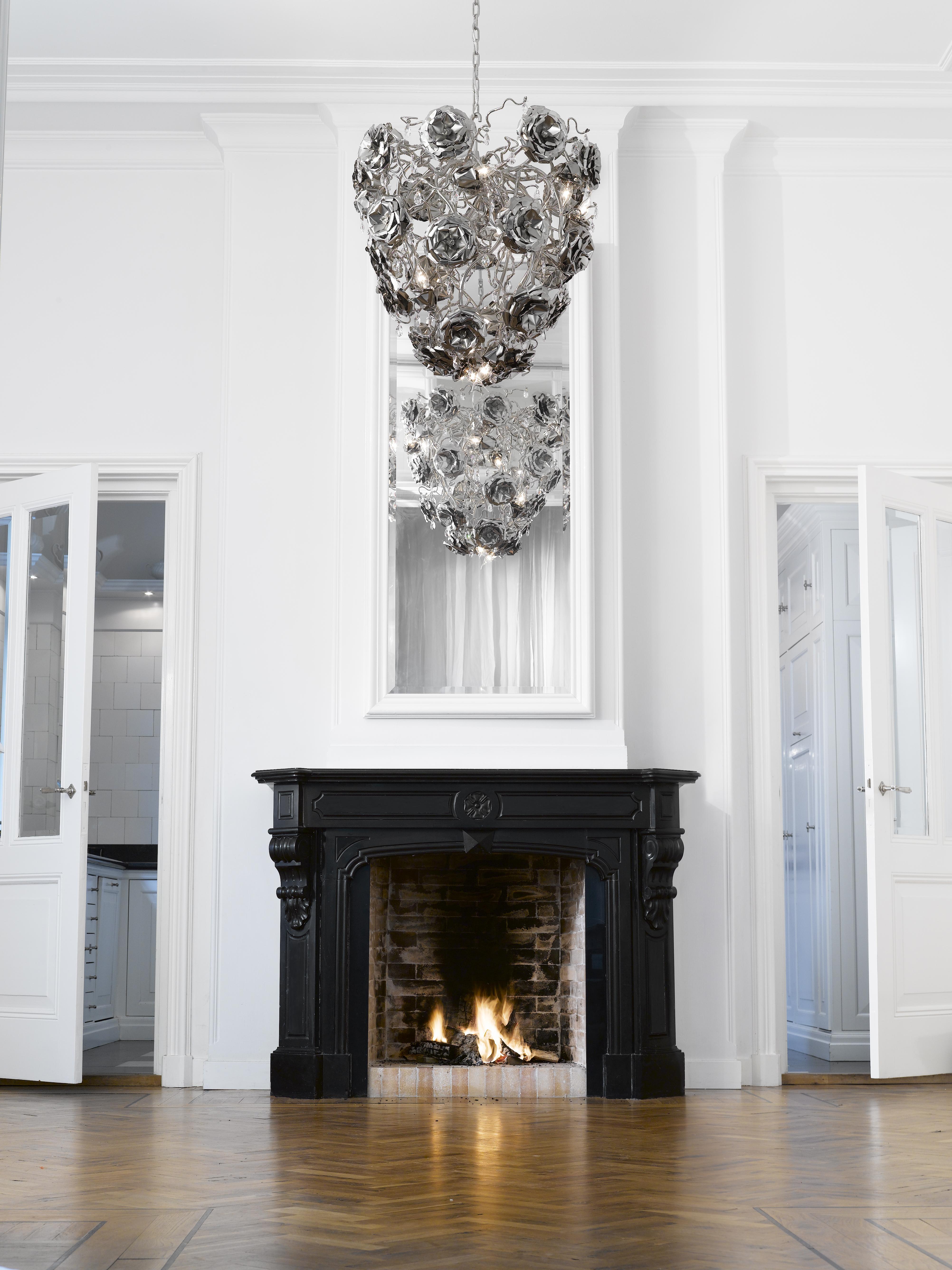 This modern chandelier in a conical shape and nickel finish is part of the Love You Love You Not collection, designed by William Brand, founder of Brand van Egmond. Evocative and eyecatching, between the handcrafted roses, sparkling crystals have