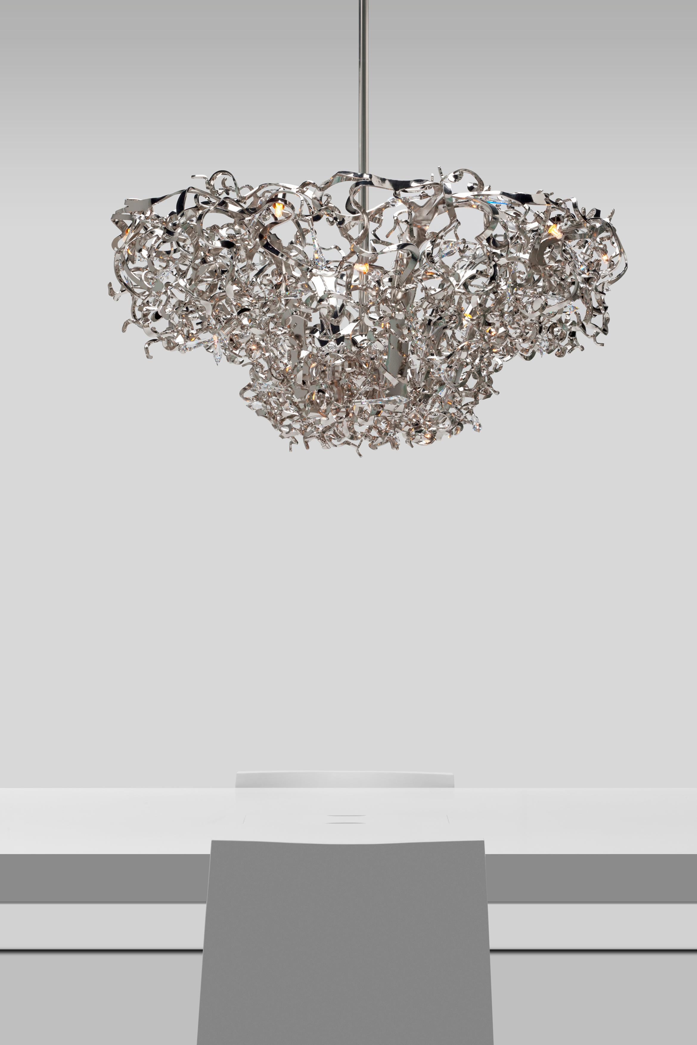 This modern chandelier in a black finish is part of the Icy Lady collection, designed by William Brand, founder of Brand van Egmond. Handcrafted in materials of the highest quality and dressed with sparkling crystals, the Icy Lady collection is an