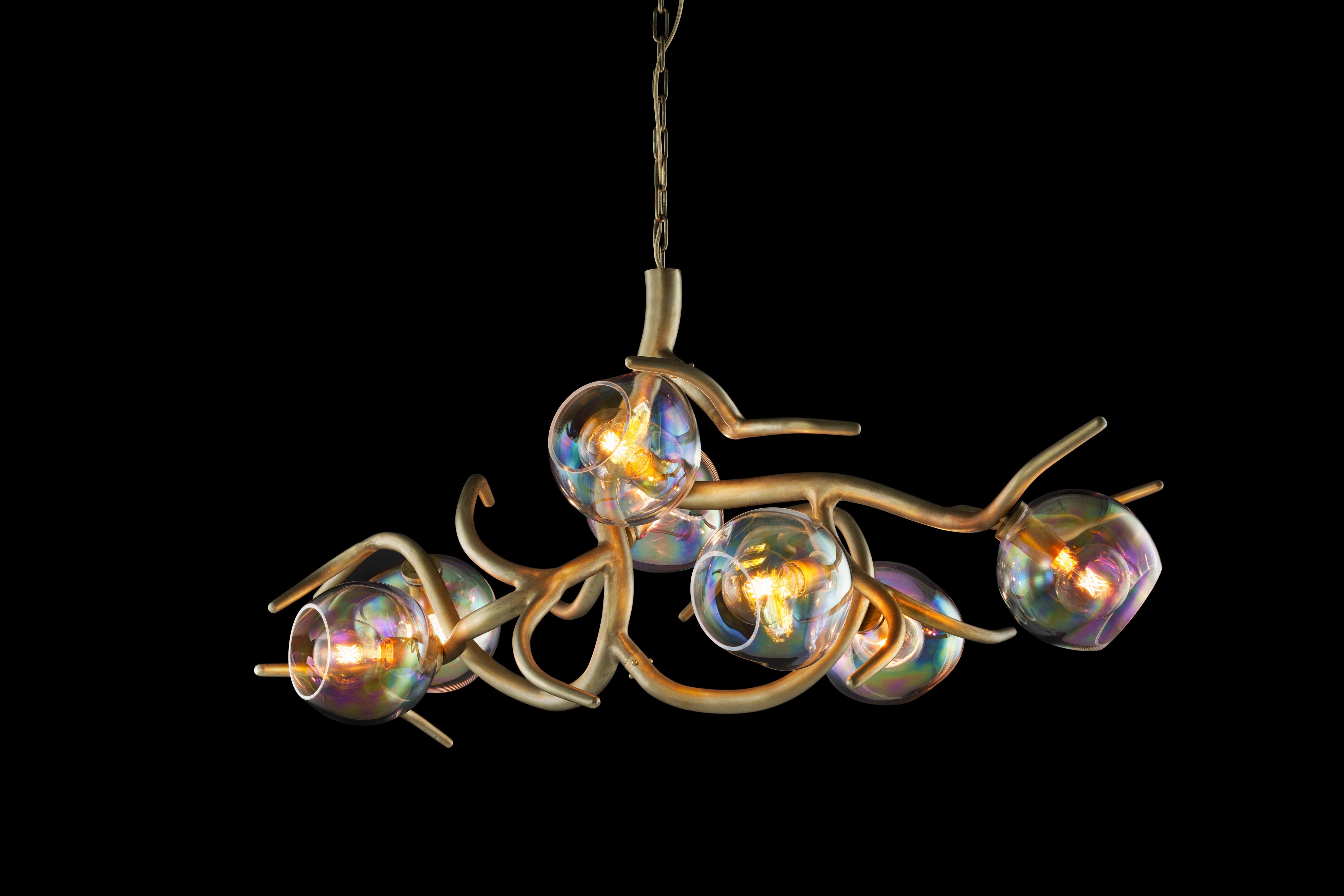 The Ersa is available in this modern chandelier oval with iridescent glass spheres, created to bring light and character into an interior, for example above a long dining table. Crafted by our craftsman and glassblowers into a beautifully organic