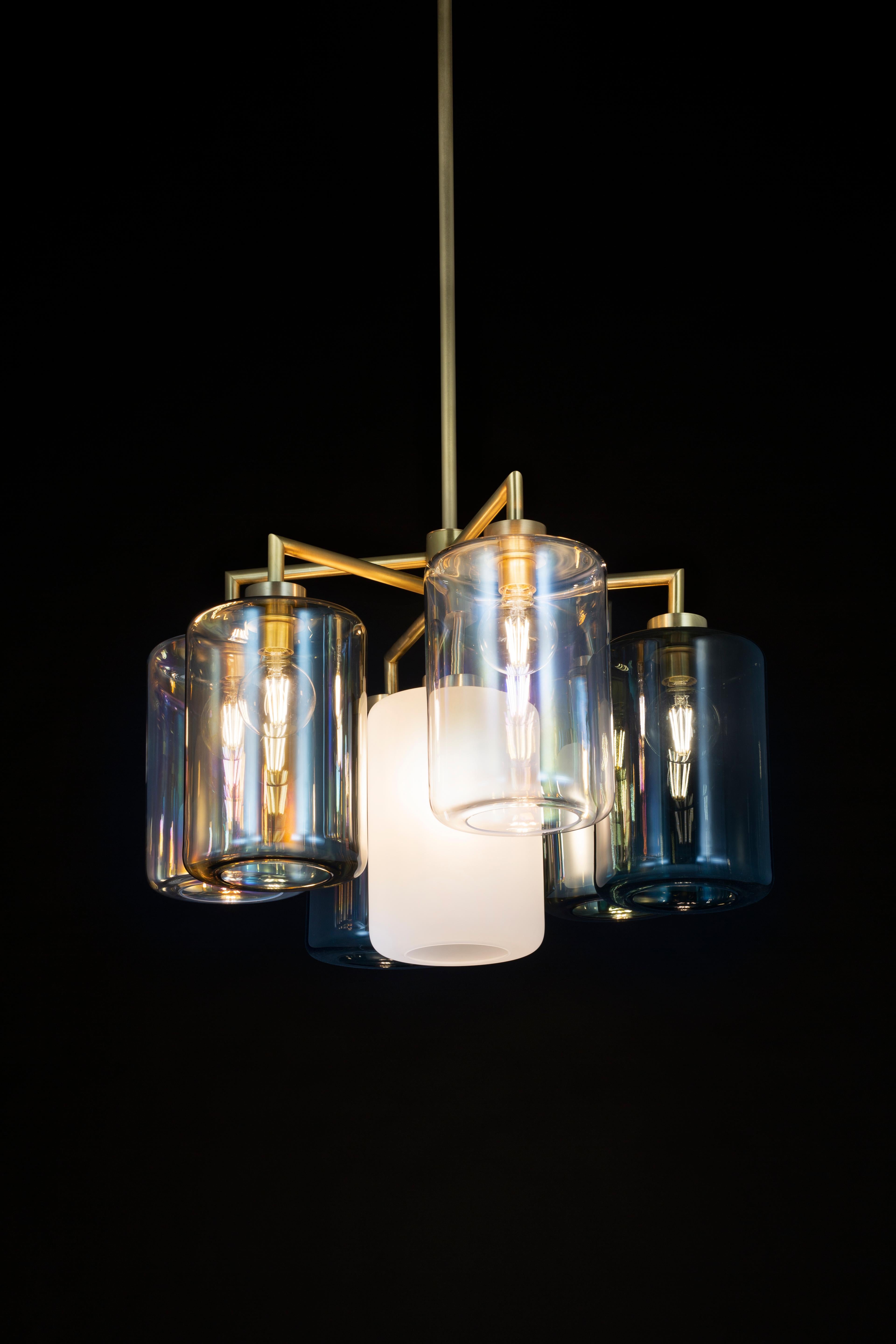 The Louise is a modern chandelier in a brass burnished finish. 

With almost carefree delight, William Brand designed the Louise collection. A simple frame, decorated in a pleasing rhythm with glass lanterns. A hint of chaos, never far away in
