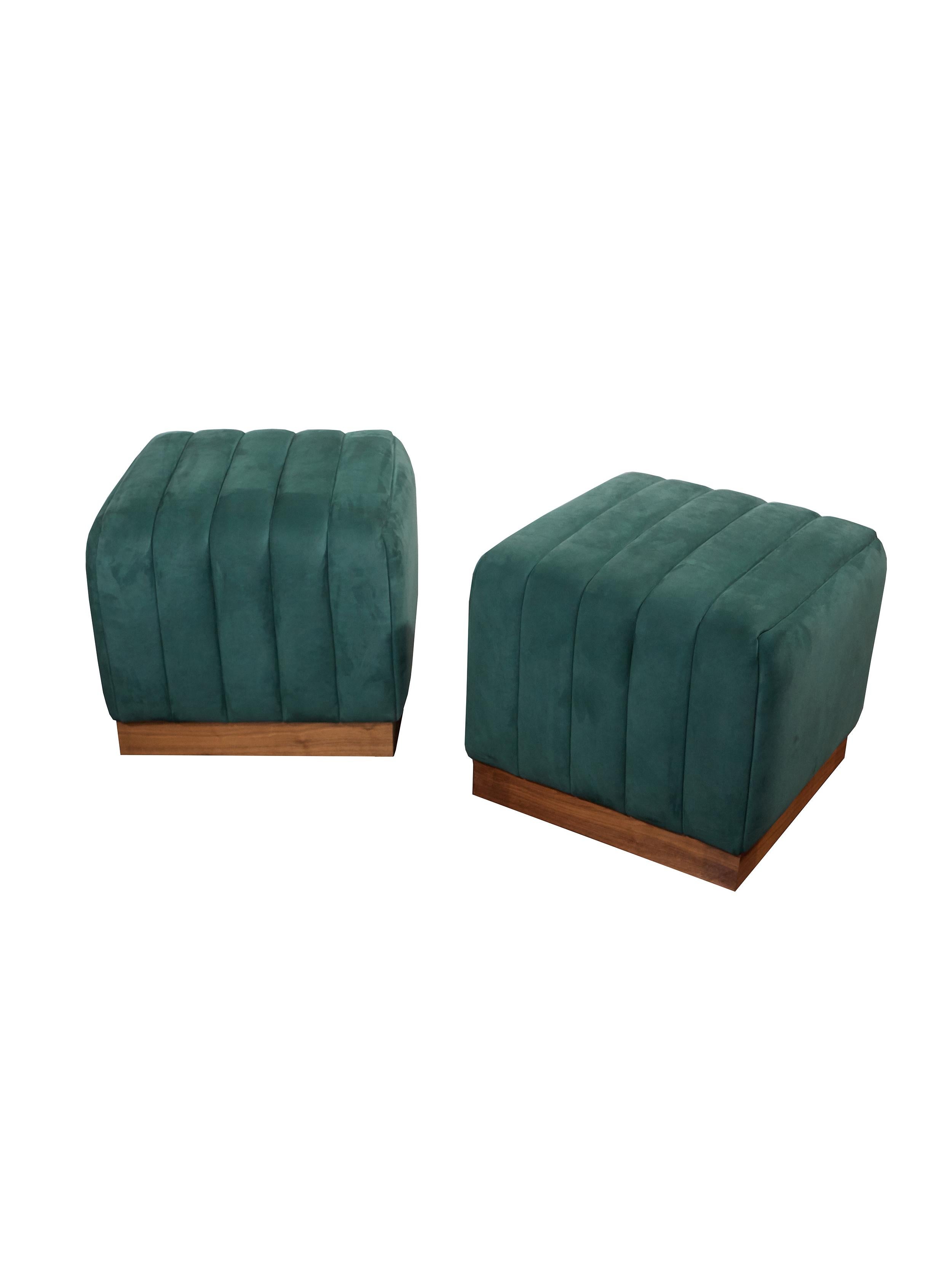 A modern ottoman with a clean silhouette, narrow channel detailing and walnut base. This fully-upholstered ottoman shown in hunter green nubuck leather is available in a variety of colored nubuck leathers. COM available.