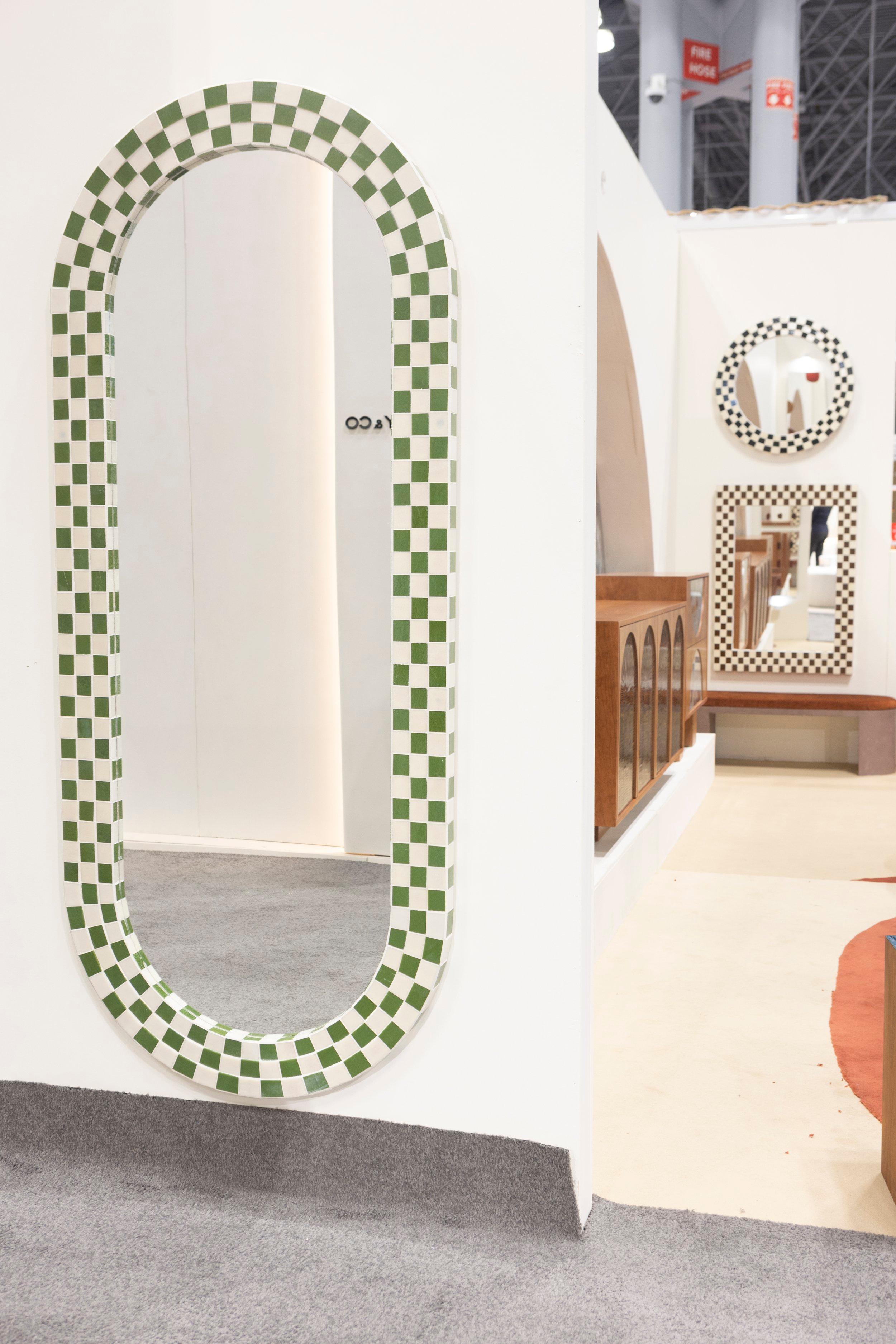 Questo specchio alto e moderno è perfetto per il tuo spazio vitale. Il mosaico a scacchiera è una miscela di vetro verde e avorio, che dà vita a un colore pulito e vibrante. Sapientemente realizzato dal team di artisti del mosaico di Ercole. Gli