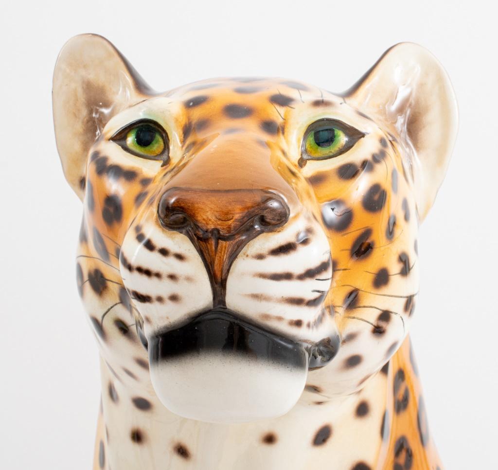 Modern large ceramic sculpture of a seated cheetah, apparently unsigned, older restorations to tail. 23.25