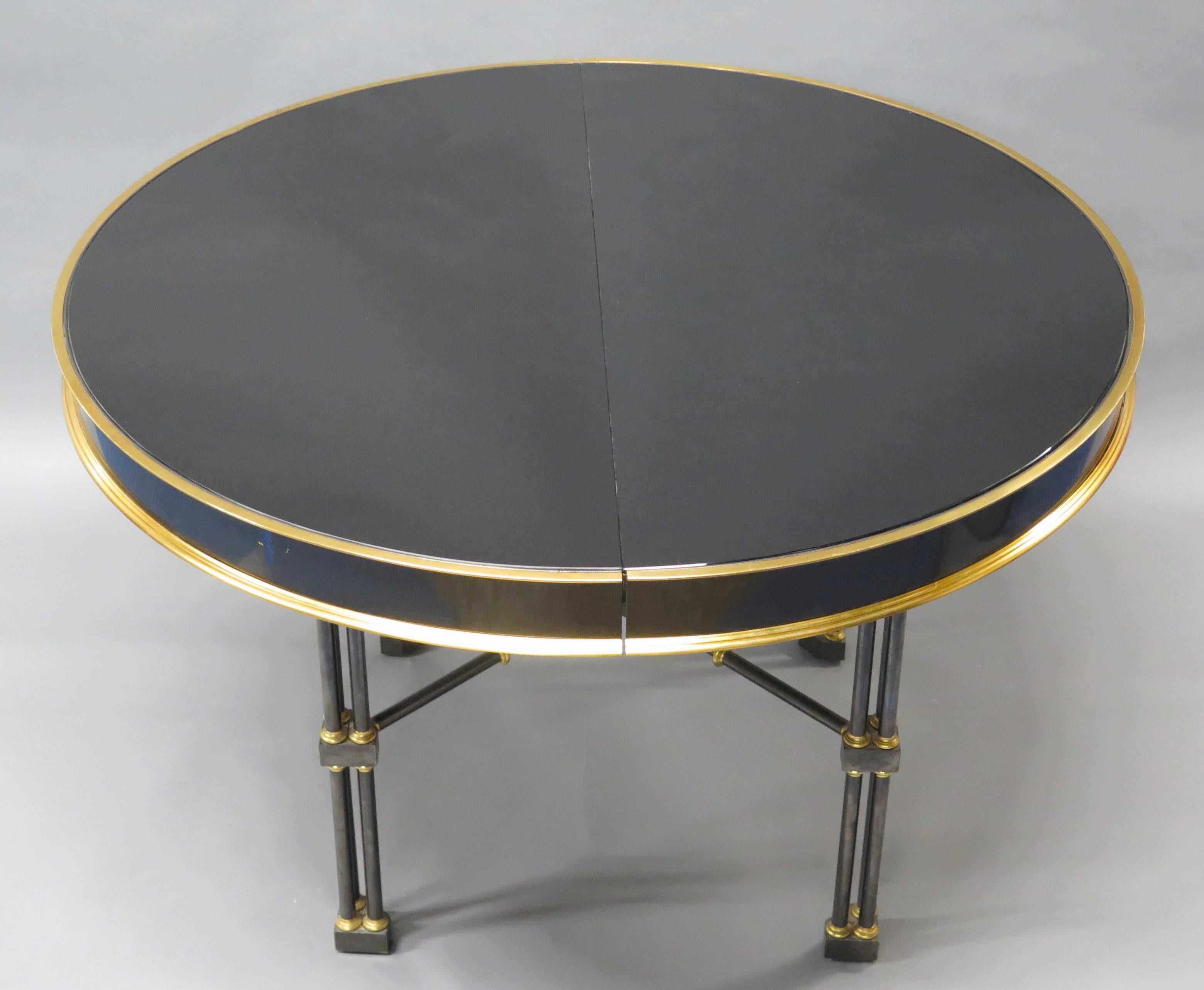 a vintage Ron Seff, Ltd. Chinese Chippendale-style / Brighton Pavilion-esque (legs resemble bamboo) dining or center table, bronze, gun metal and polished brass with black high gloss industrial glass top, seam down the middle once allowed leaf or