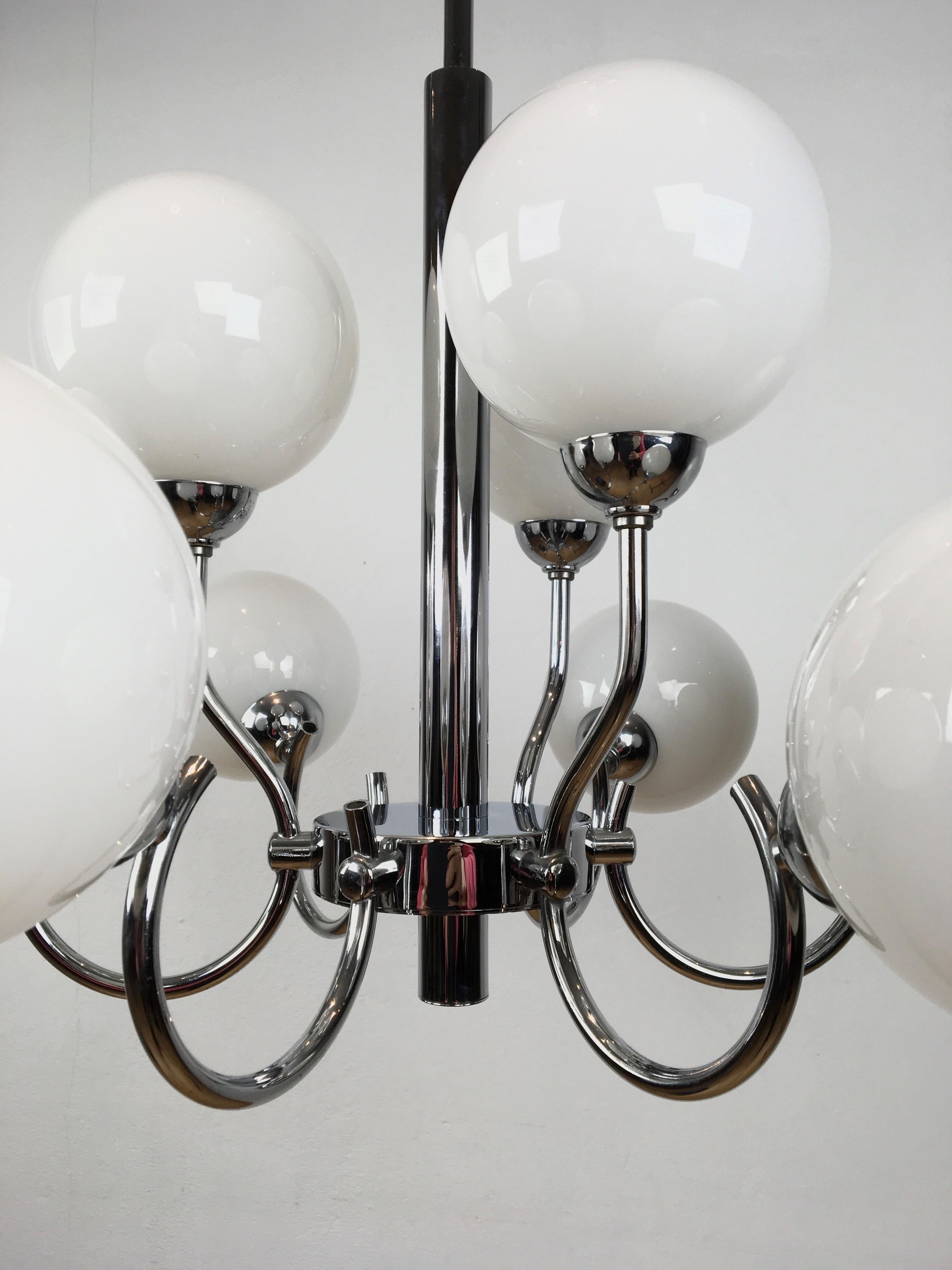 Modern chandelier of chrome with 9 opaline glass globes. 
The handblown opaline glass globes are positioned in 2 levels: 6 below and 3 on top. 
Chrome is still in beautiful condition; only under at the middle point a kind of discoloration. 
 