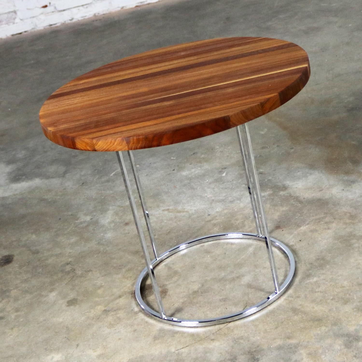 Fabulous medium sized round modern side table or end table with chrome base and walnut top attributed to Milo Baughman. It is in excellent vintage condition with age appropriate light wear, circa 1960s-1970s.

This incredible end table is really