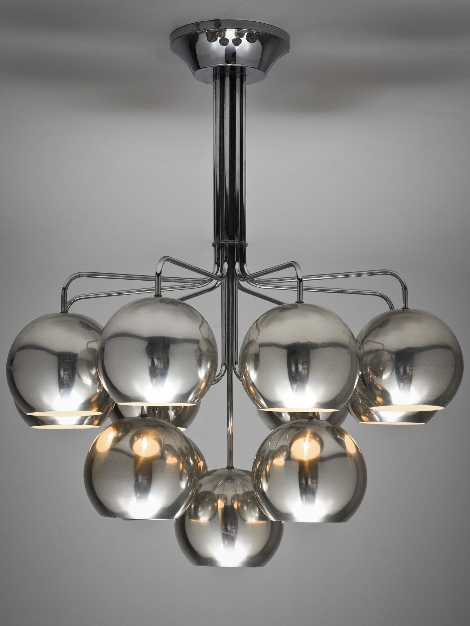 Chrome pendant, Germany, 1970.

This chrome pendant is wonderfully stately and at the same time minimalistic in design. The color of the chrome is muted and light to almost green on the inside. The vertical rod that holds all the chrome balls