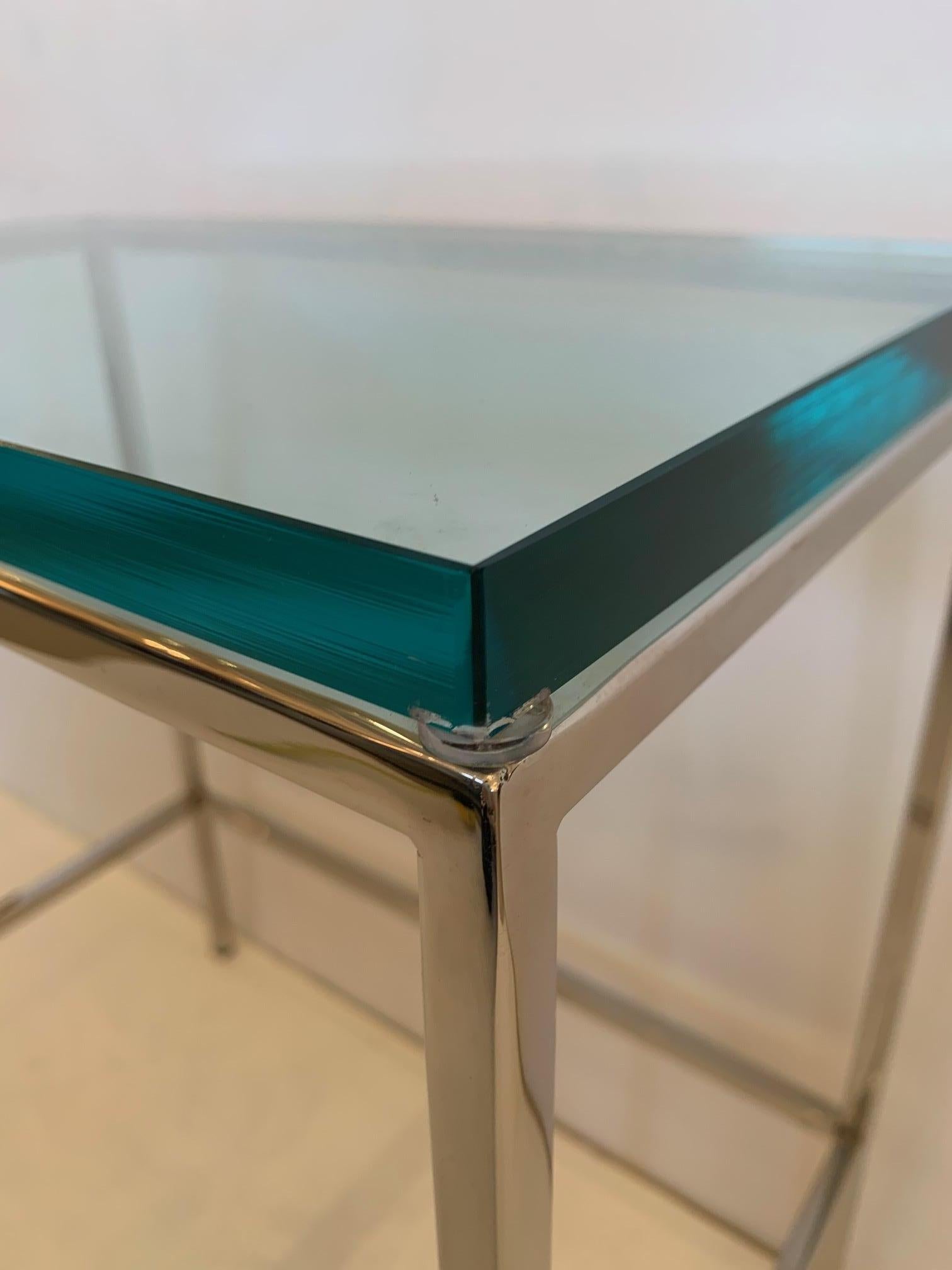 A versatile modern chrome and glass top martini table with clean lines and .75 luxurious thick glass.