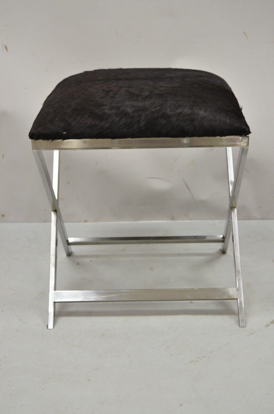 Modern Chrome Frame X-Frame Metal Stool with Cowhide Upholstery. Item features cowhide upholstery, metal chrome x-frame, clean modernist lines, great style and form. Circa late 20th Century - 21st Century. Measurements: 21