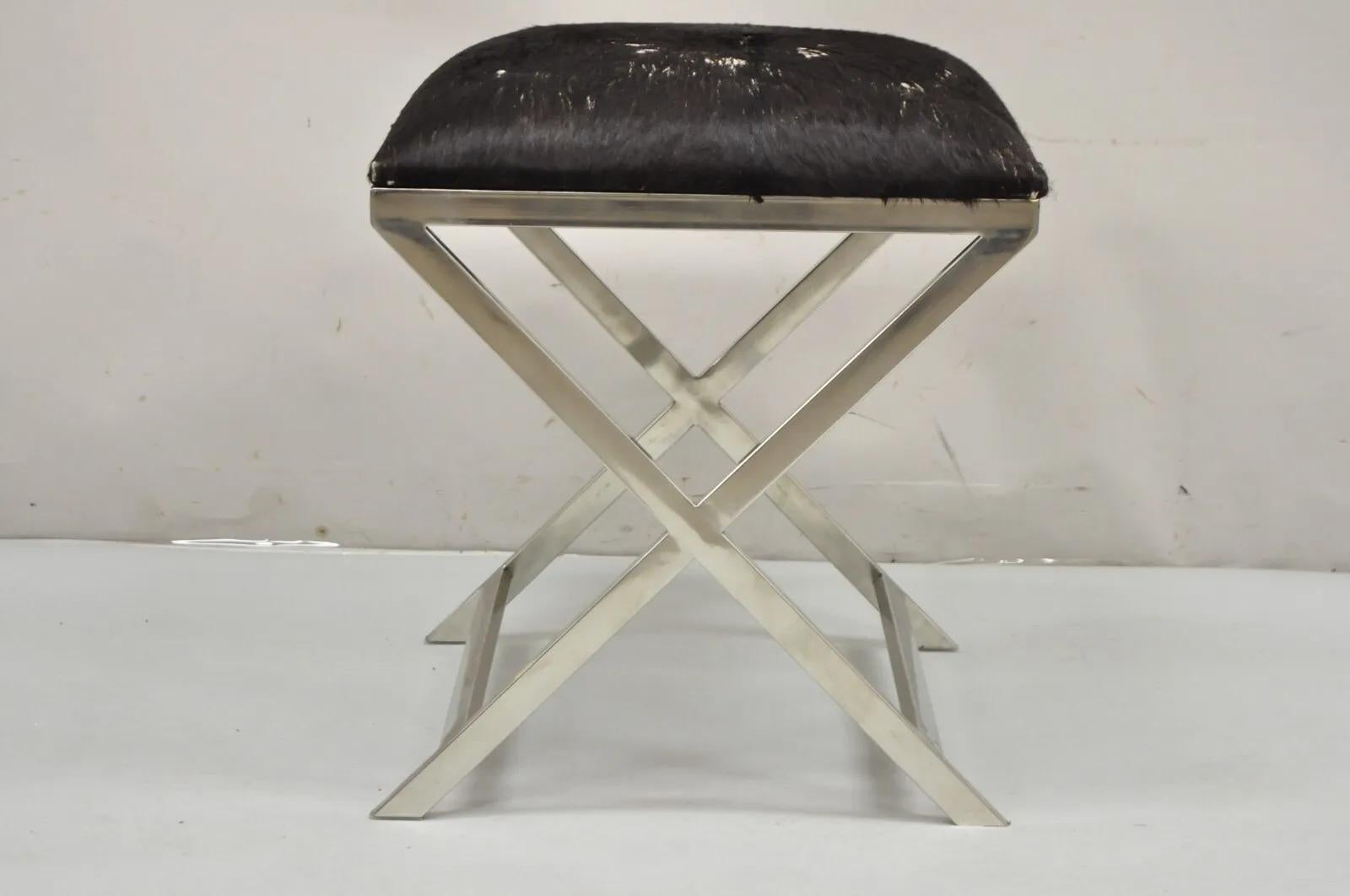 Modern Chrome Frame X-Frame Metal Stool with Cowhide Upholstery. Item features cowhide upholstery (with damage), metal chrome x-frame, clean modernist lines, great style and form. Circa Late 20th Century - 21st Century. Measurements: 21
