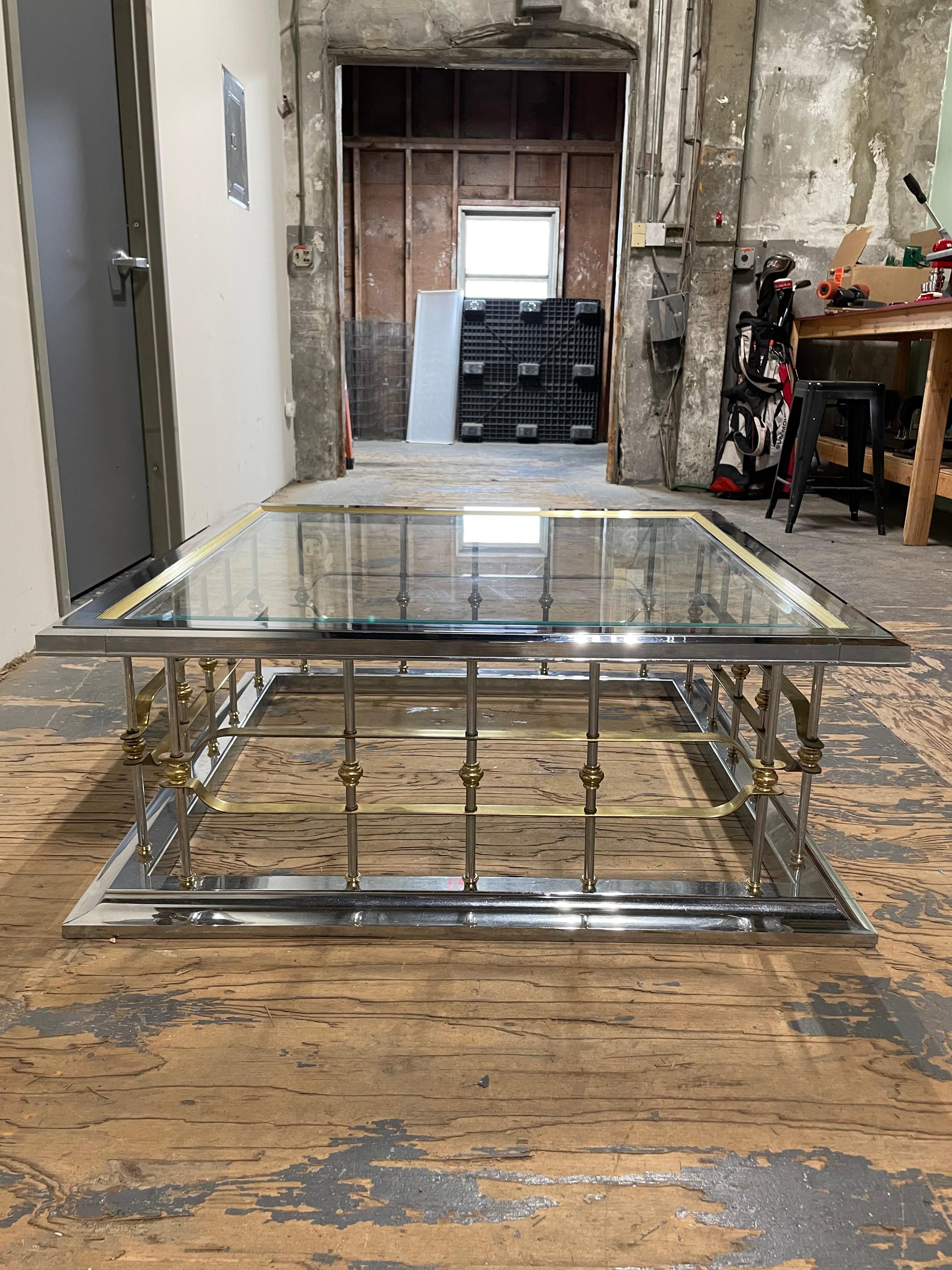 Vintage 1970's chrome, brass, and beveled glass coffee table. In the manner of Mastercraft with a modern Erwin Lambeth style.