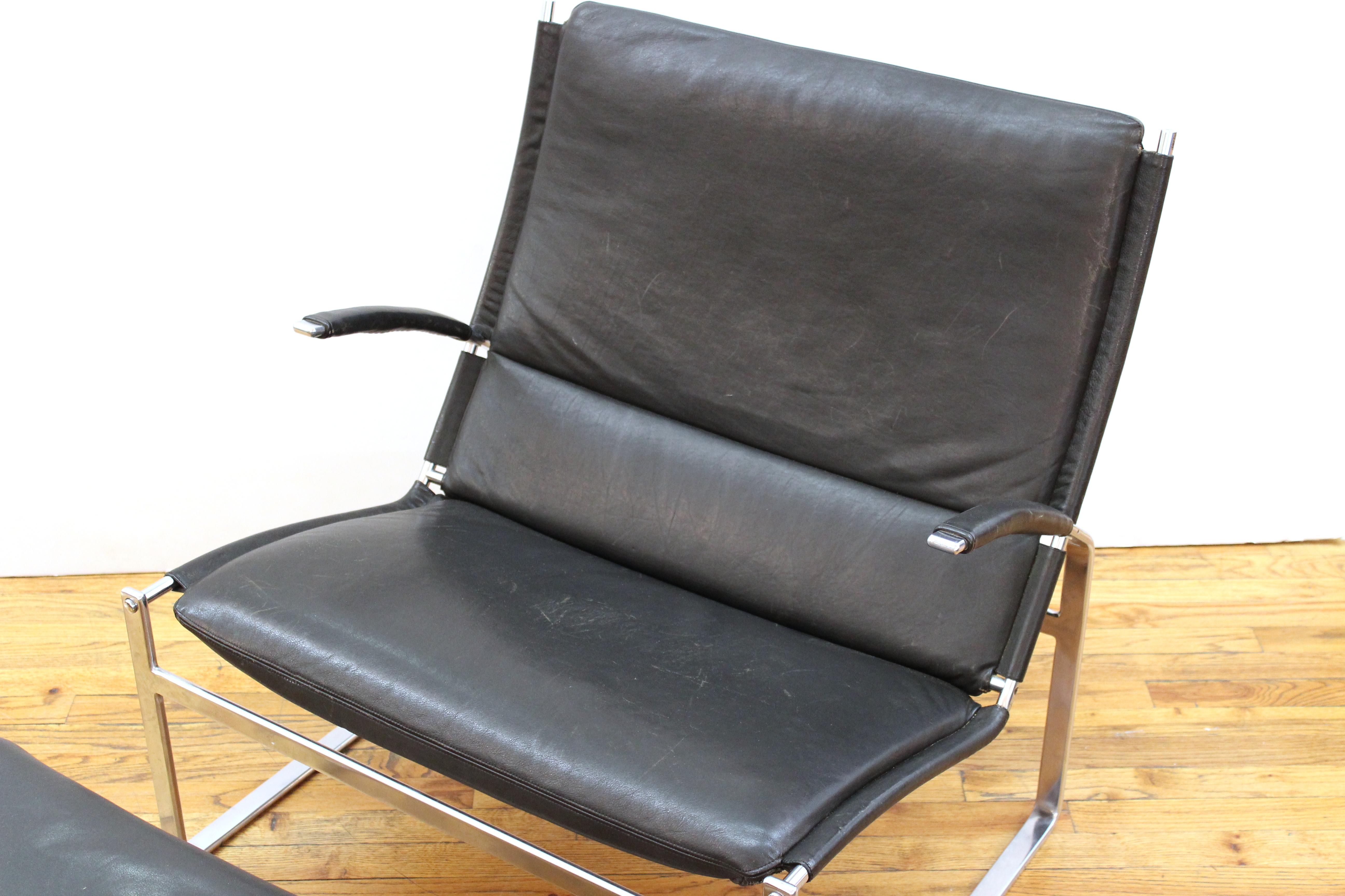 Modern chromed metal lounge chair and ottoman, in leather upholstery. 32