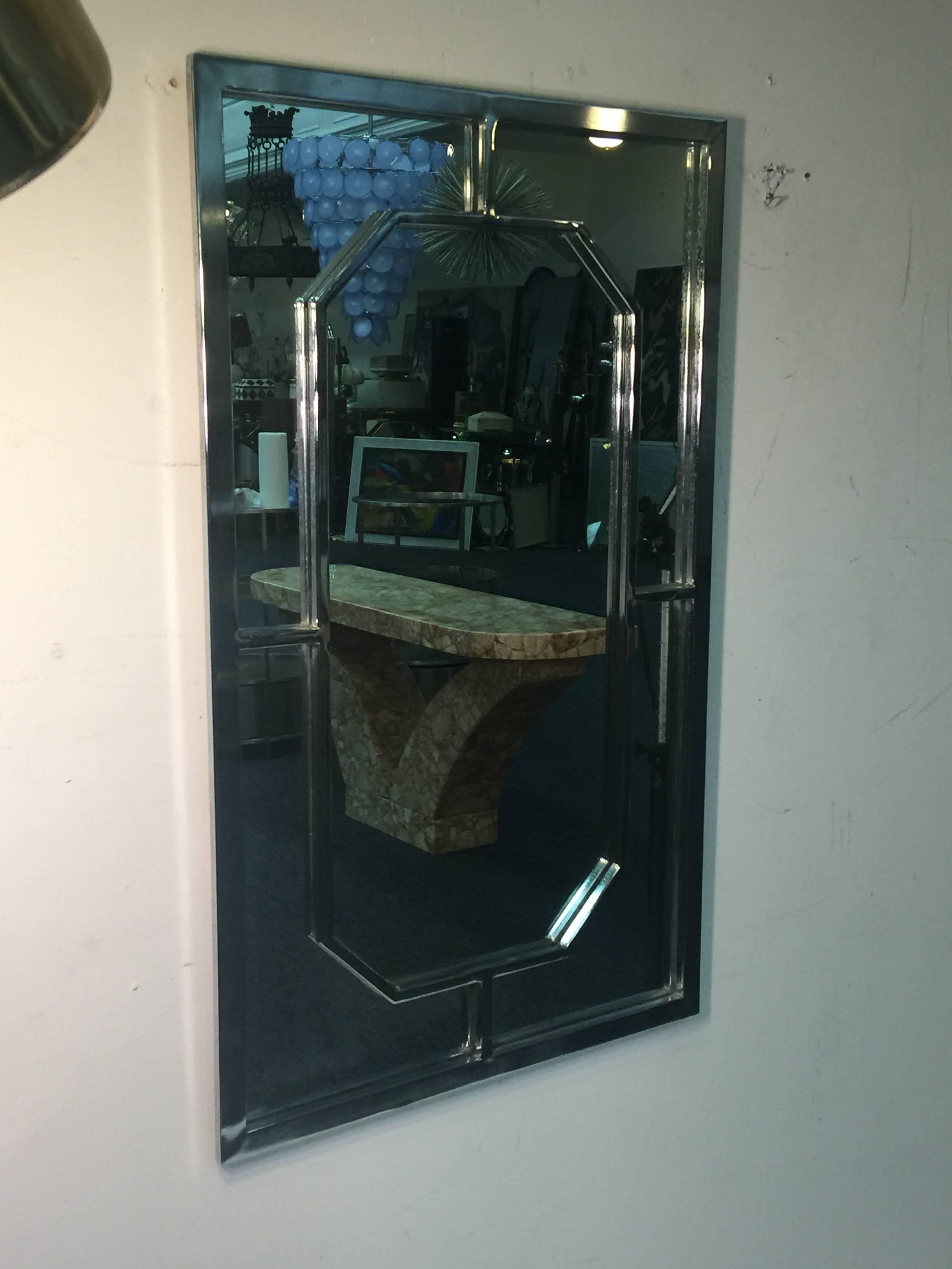 Rectangular modern chrome framed mirror with elongated octagonal chrome framed design center. Designed in the 1970s in the manner of Milo Baughman.