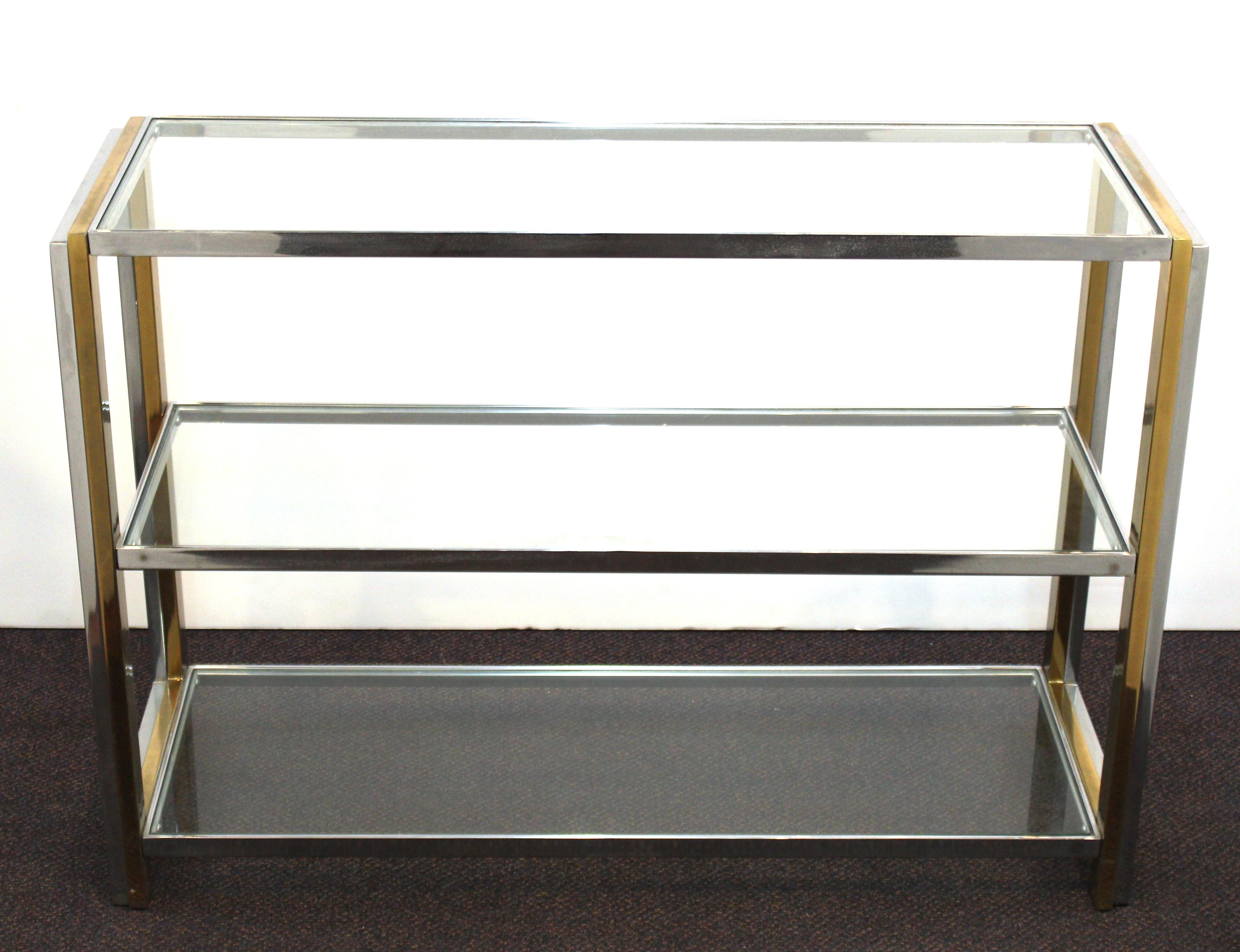 Modern sideboard in chromed metal with glass shelves. The piece has three levels of glass shelves and is in great vintage condition with age-appropriate wear.
