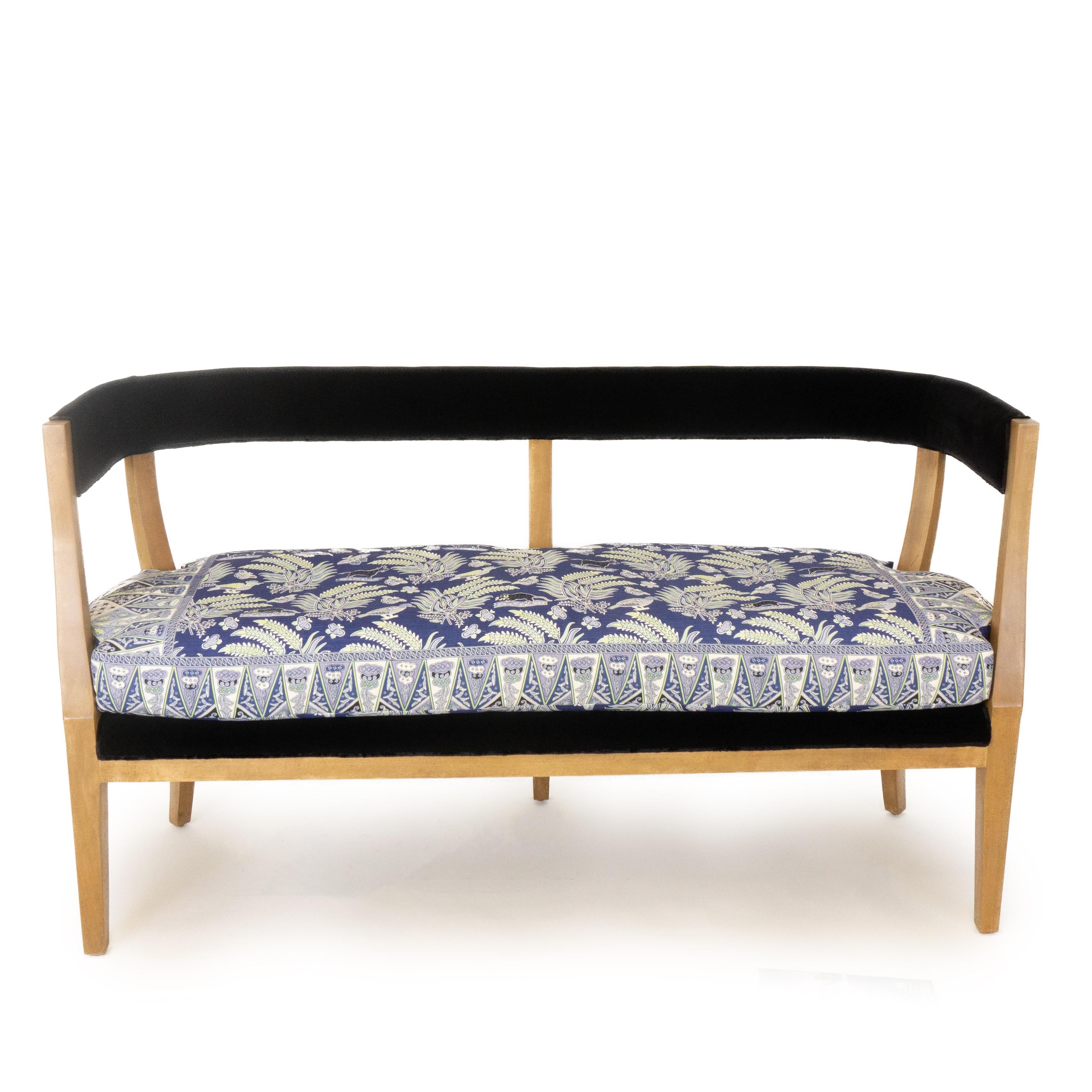 Modern classic curved back bench upholstered with black velvet and botanical patterned loose cushion. Exposed poplar legs finished and stained by hand. The exposed wood leaves some visible natural markings. Hand carved and sculpted in our studio in