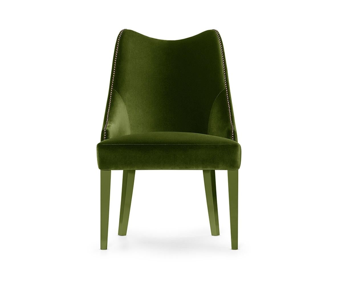 This Chair is the epitome of serenity inducing design. With an embracing silhouette and luxurious deep seat, its sensuous curves and comfortable back perfectly adapt to the body. The nails adorning the curves and back of the pieces provide a