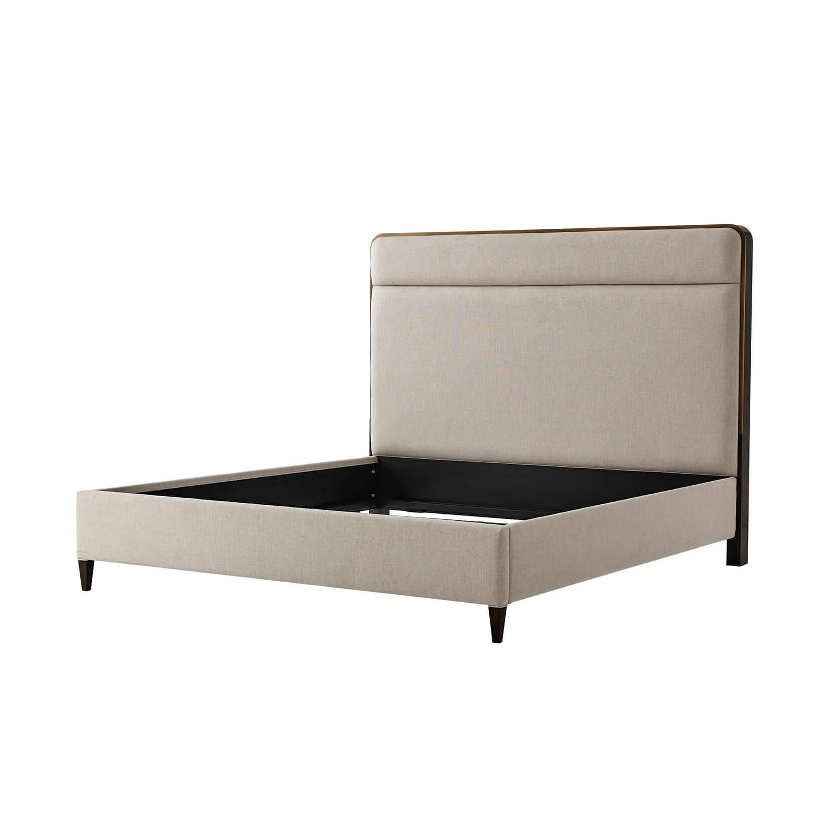 Modern Classic king size bed with brushed Pyrite finish headboard surround, upholstered headboard with a horizontal channel detail, upholstered rails and raised on square tapered legs.

Dimensions: 82.25