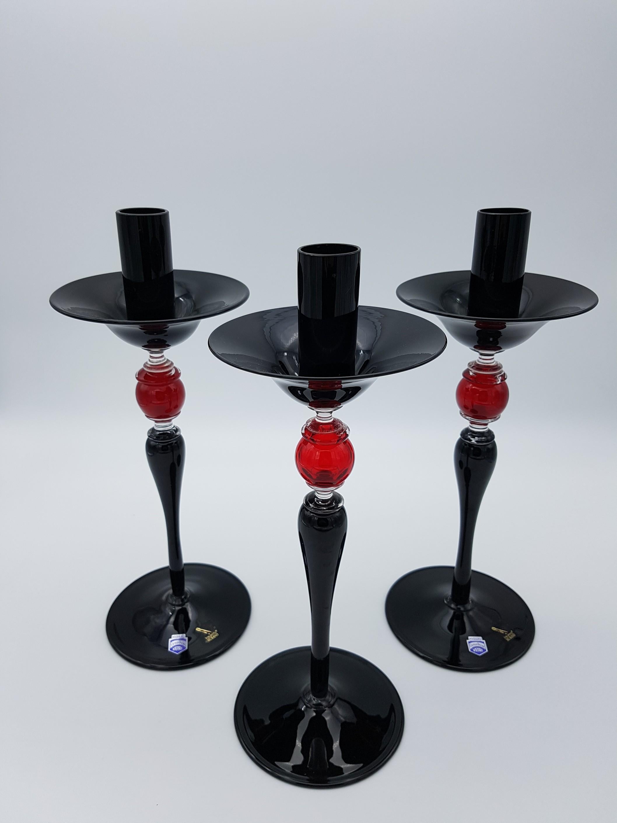 This impressive set of three Murano glass candlesticks retain all the flavor of Classic Venetian home decor but with the added bonus of vibrant modern colors. The candlesticks have been mouth-blown and handmade by Gino Cenedese e Filgio in the early