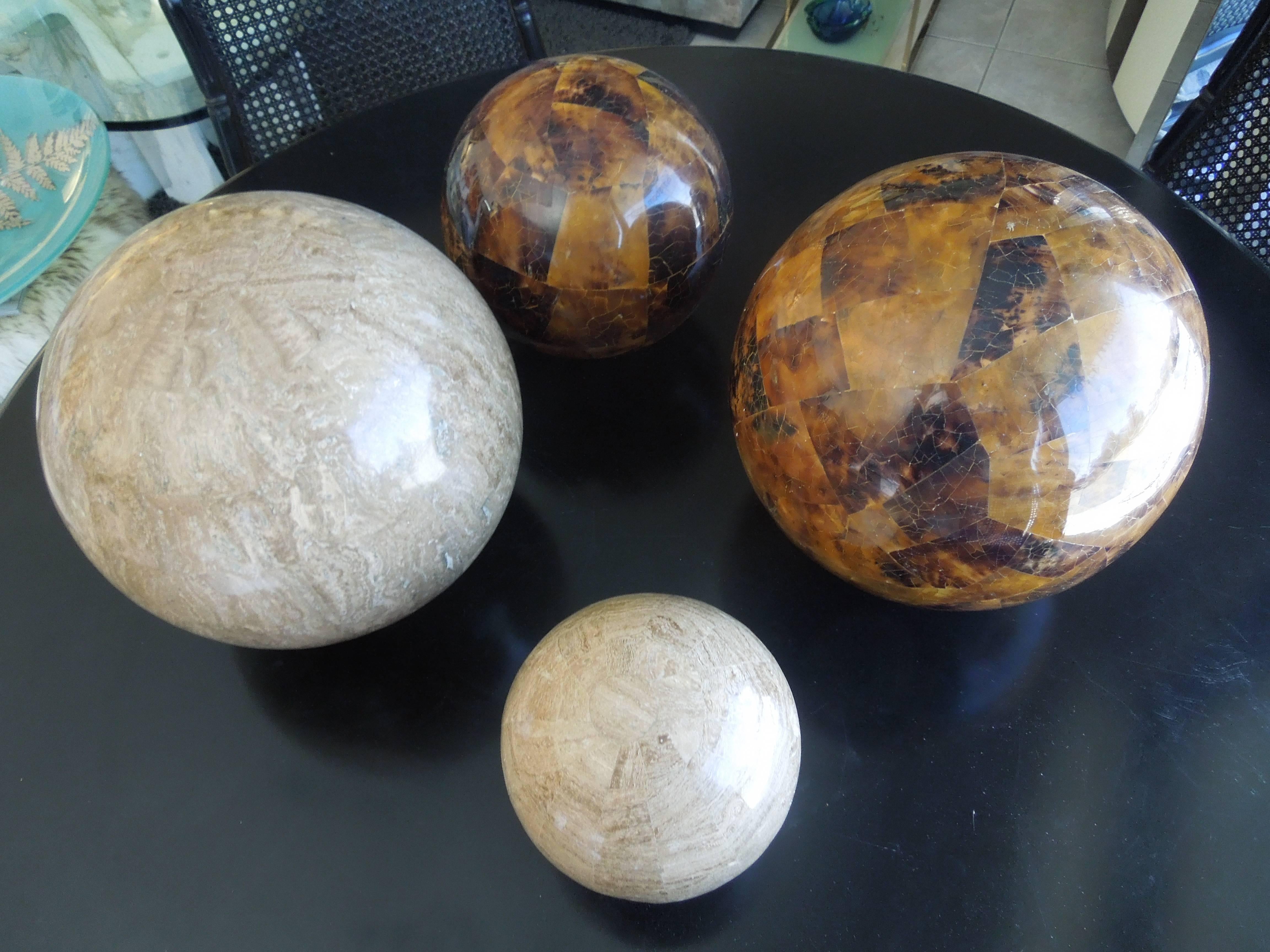 From a very upscale estate in Palm Springs, CA are a set of rare tessellated stone spheres. Two are in travertine stone and two rare dark brown color stone. They were made by hand in the Philippines for Maitland smith. They appear perfectly round on