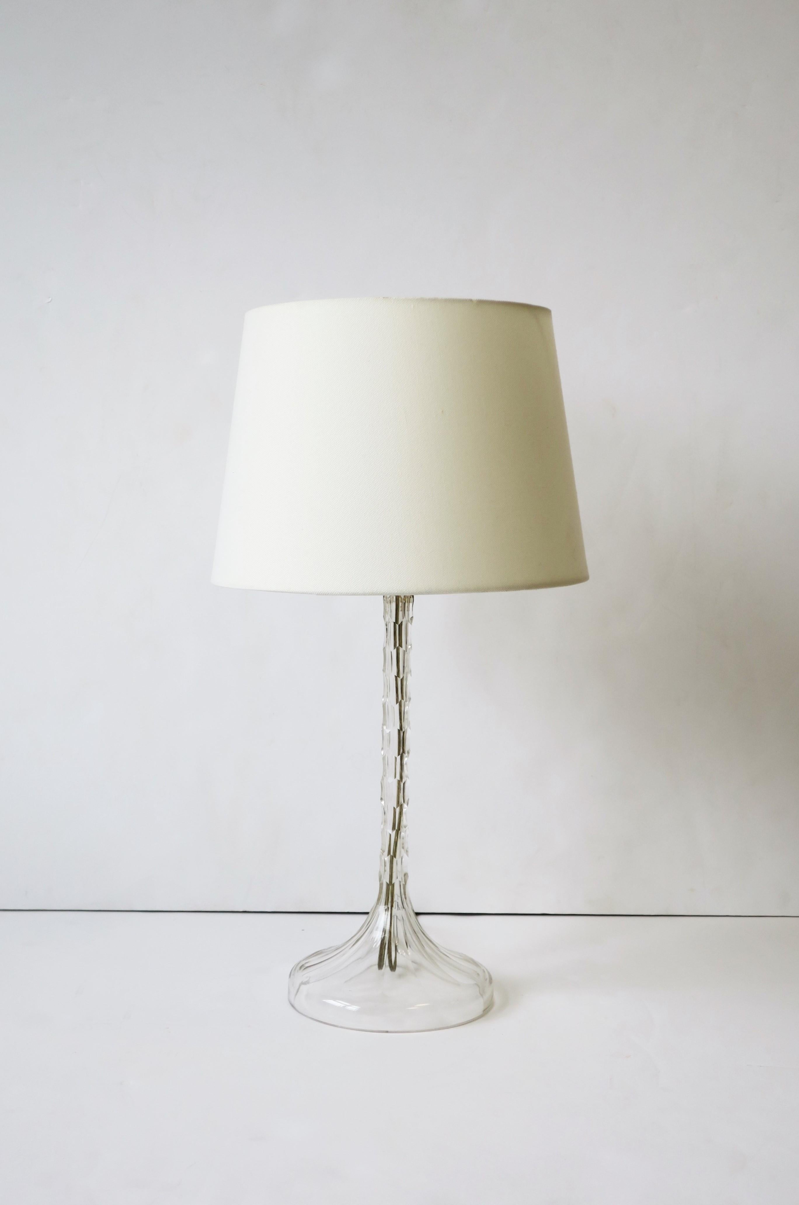 An elegant European clear cut crystal desk or table lamp, circa 20th century. A beautiful lamp with modern cuts up and down entire lamp. Lamp is made from one piece of crystal. Lamp could be convenient for a small space, a desk, closet, vanity,