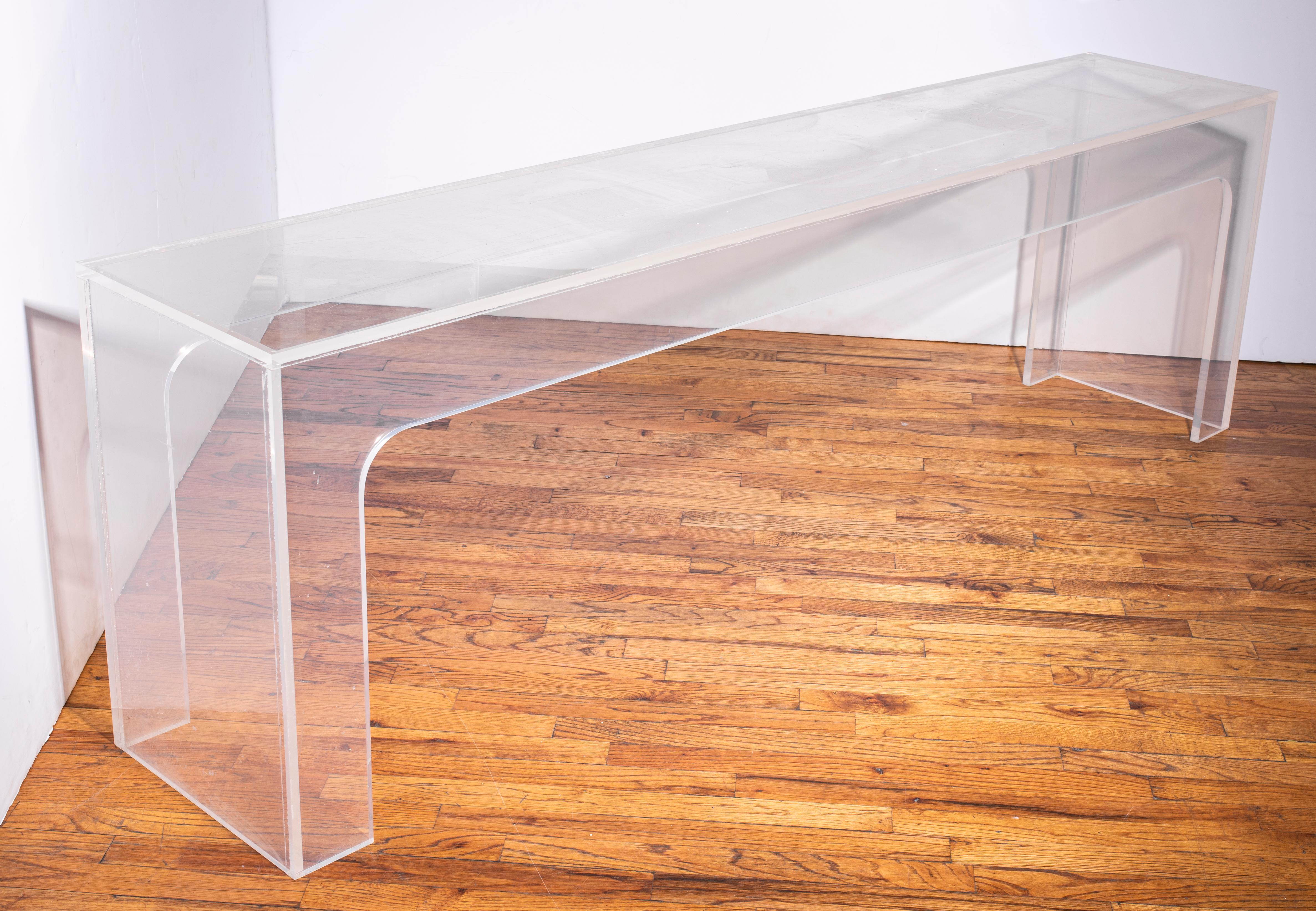 Modern clear Lucite console table, circa 1970s. In great vintage condition with age-appropriate wear and minor surface scratches to the top.