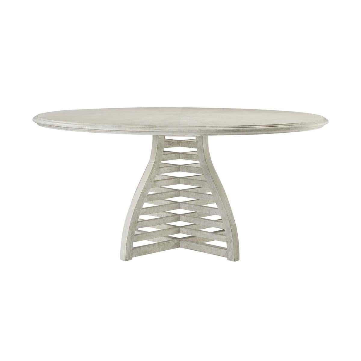 Modern coastal dining table, functional and visually appealing, the slatted dining table is the perfect dining table for your party of four. This uniquely designed table reflects a sunburst patterned top with a shaped slatted base. With a