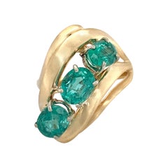 Vintage Modern Cocktail Ring Featuring Three Oval Emeralds in Yellow Gold, Circa 1970