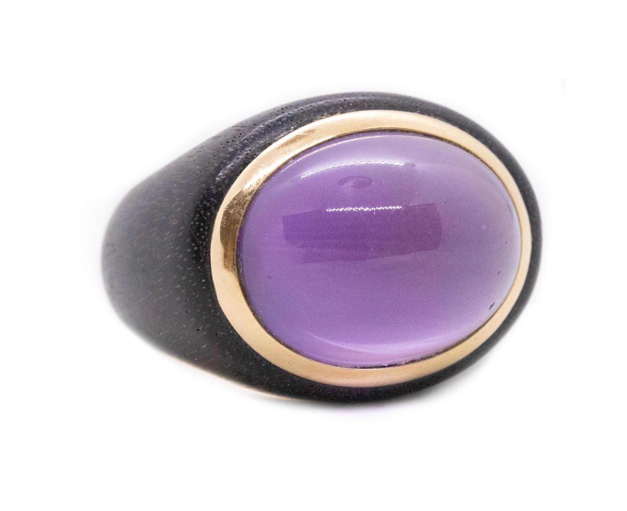 A contemporary rosewood ring.

Modern contemporary cocktail ring made with carved natural rosewood and 18 karats yellow gold. Bezel set on top, with one oval cabochon cut (20 x 16 x 8 mm), of delicate lavender jade quartz with a weight of 18.32