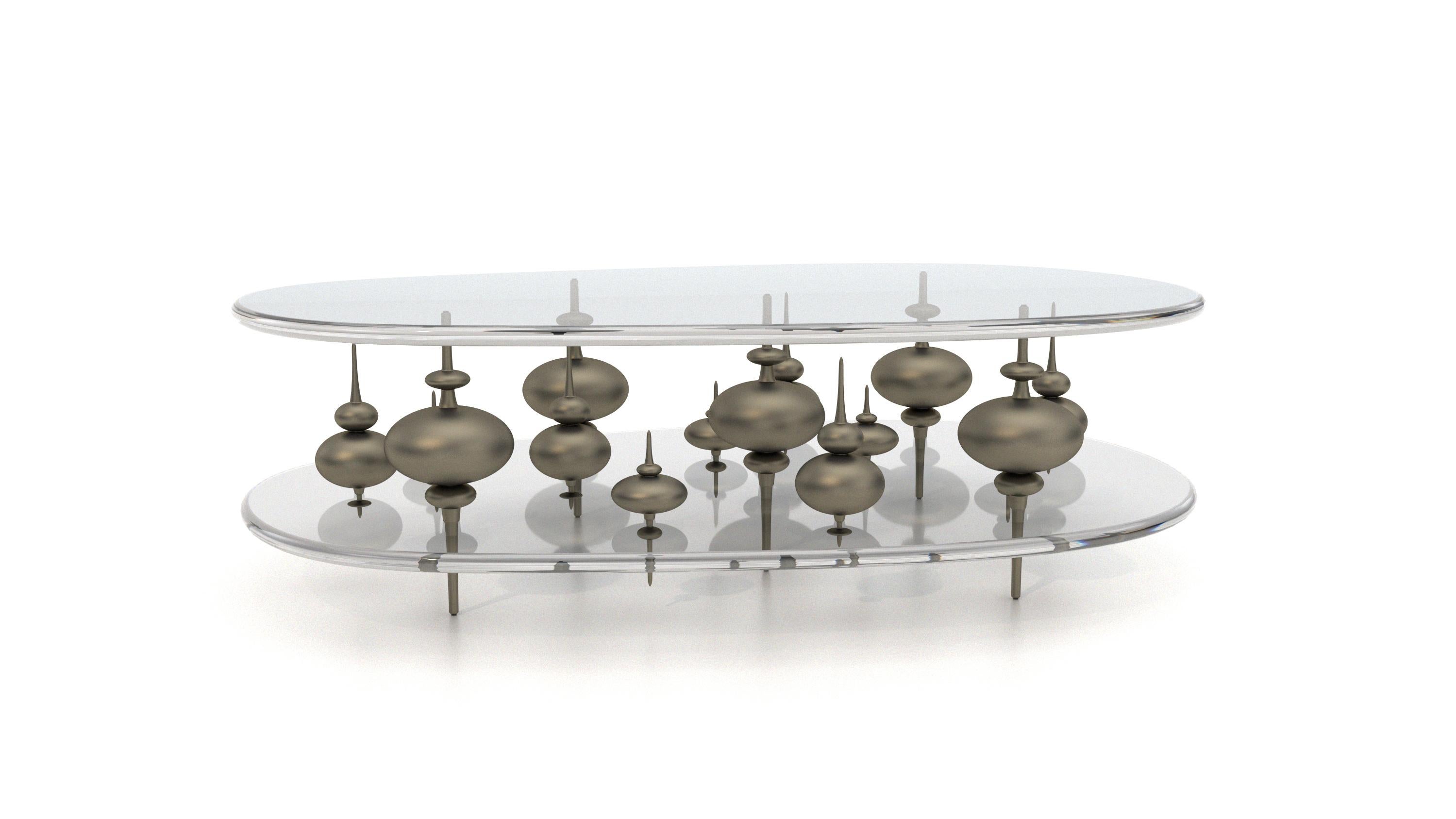 The Minaret cocktail table is inspired by how the rooftop spires pierce through the clouded skyline of Istanbul Turkey. 15 cast bronze elements, hand fabricated at a world renowned foundry in Tucson Arizona, float magically between two crystal clear
