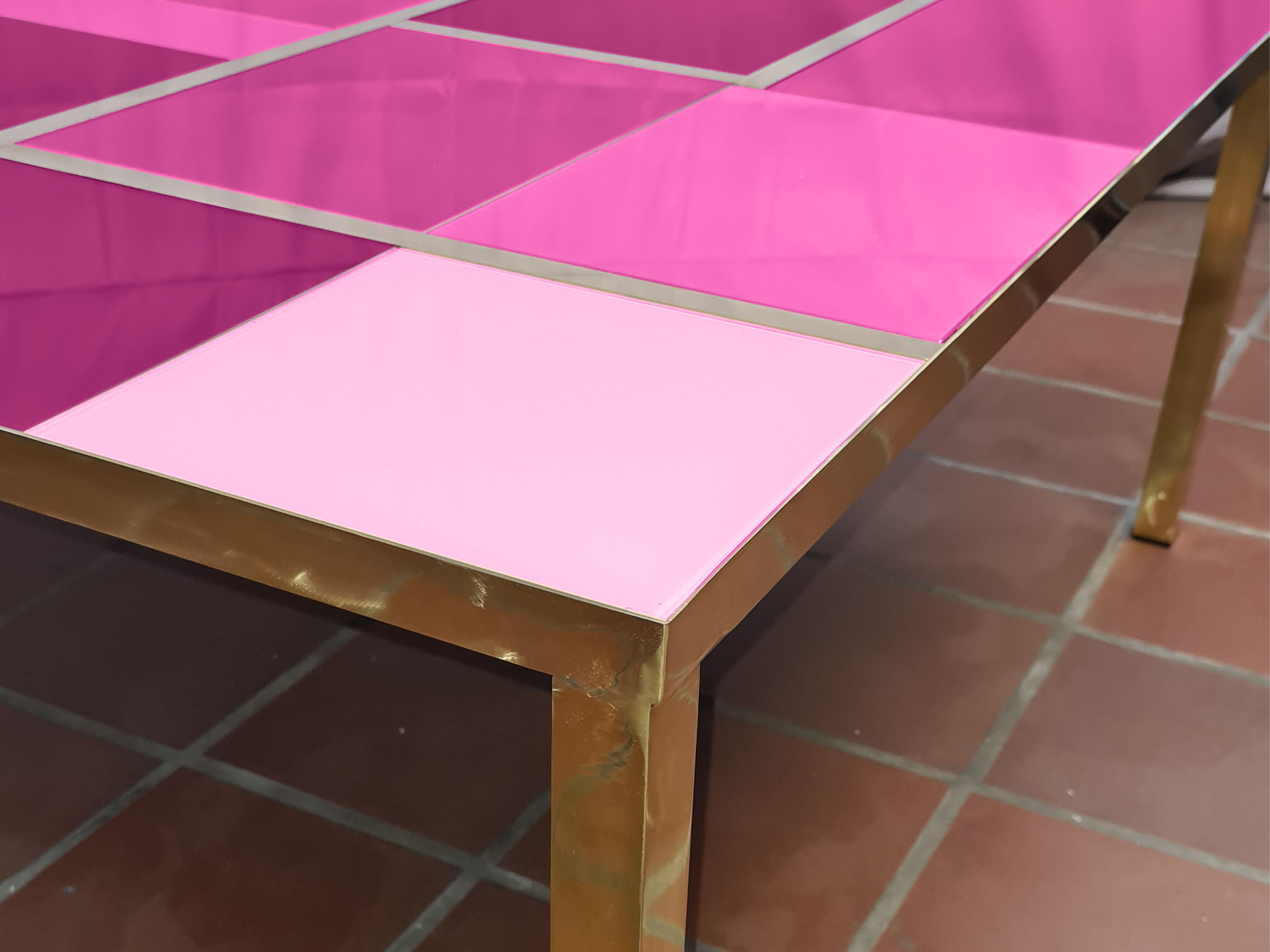 This modern purple Murano glass coffee table with brass trim is a striking piece that embodies Italian craftsmanship. 

The purple glass top features several shades of the same color with a unique design that showcases the skill of Murano