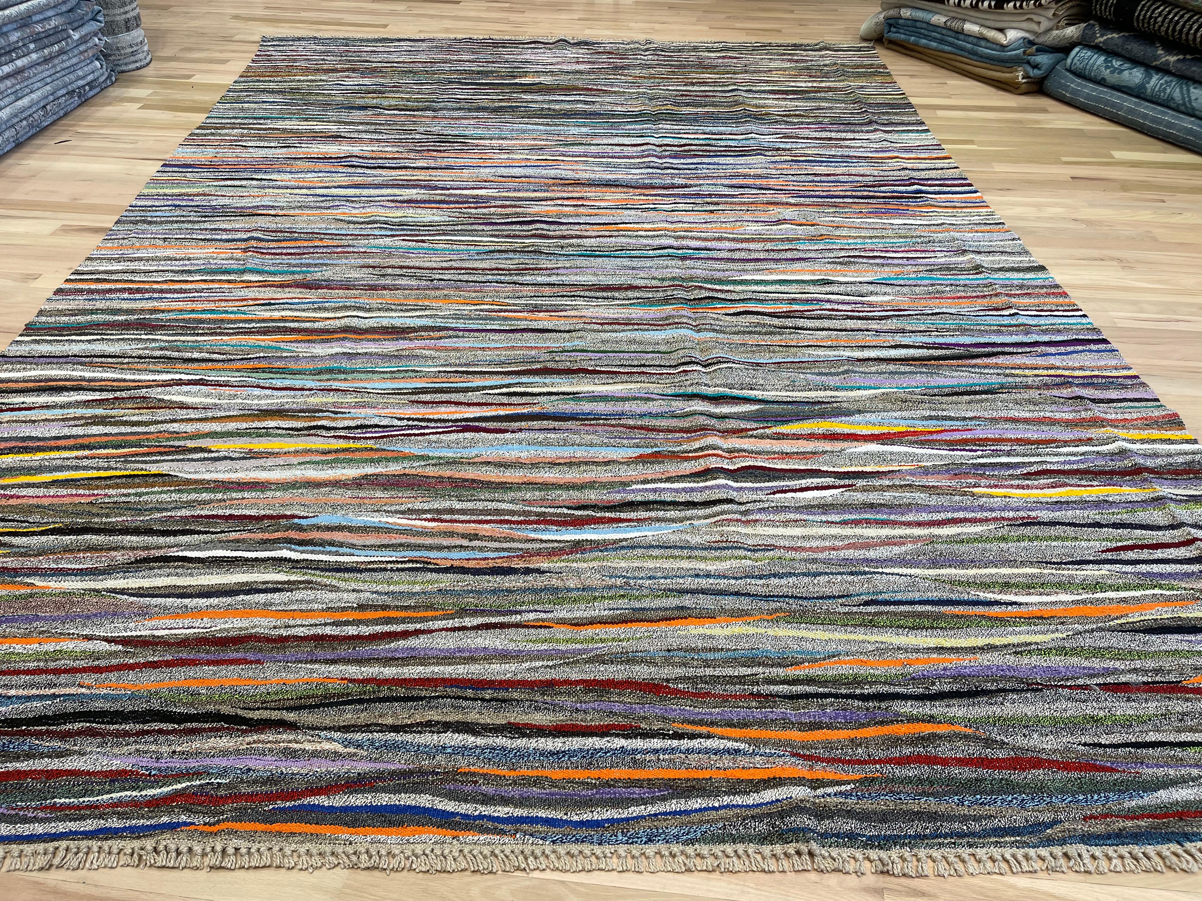 This Turkish rug features a colorful wave design and is reversible, allowing you to switch up your decor. Add a touch of style to any room while also having the option to change things up to suit your mood. Beautiful and versatile, this rug is a
