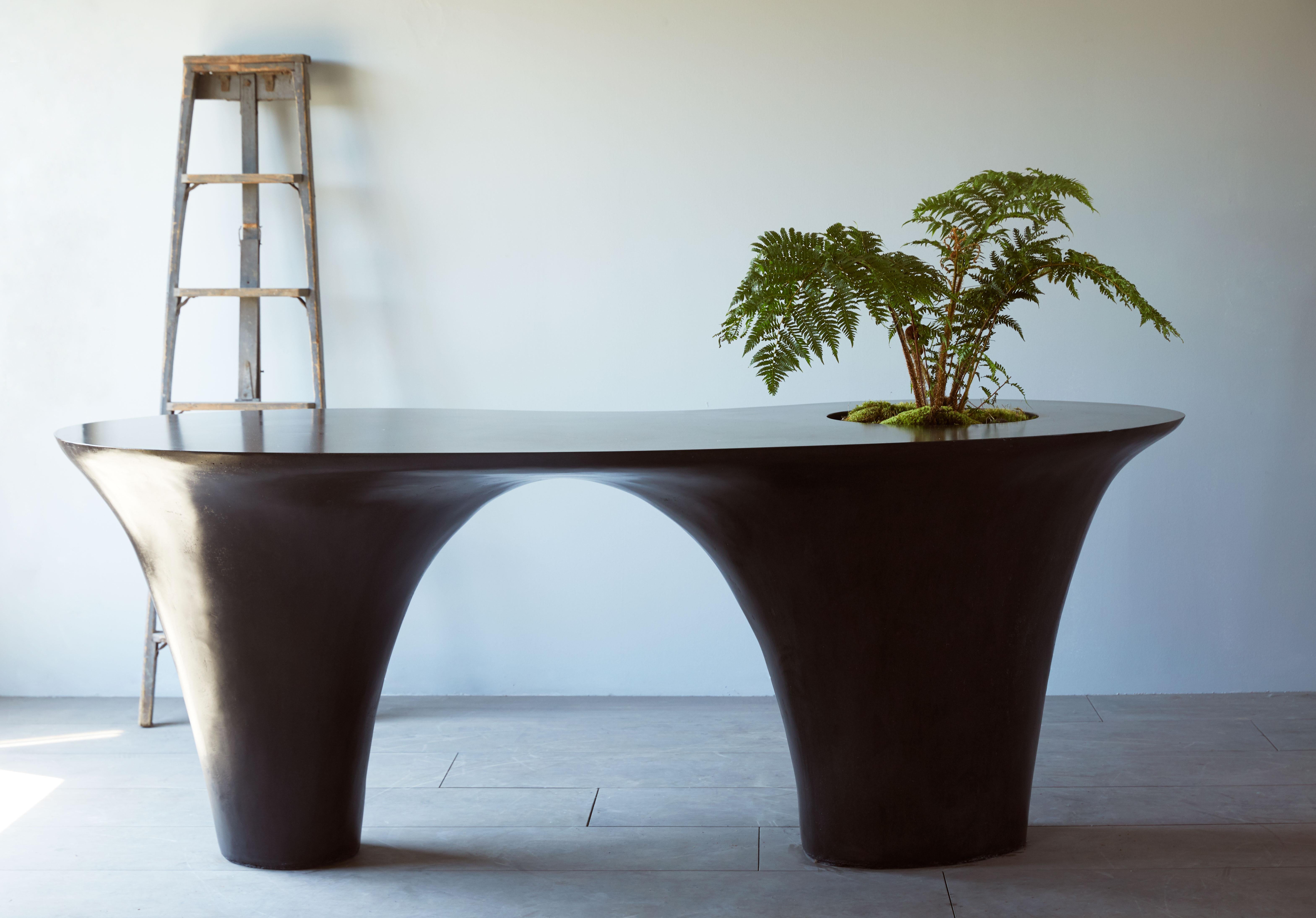 This organic, modern table will enhance and add a distinctive style to any space indoor or out. It is made in Brooklyn of  hand-sculpted, polished, and sealed concrete and features an optional built-in planter.

DETAILS
Indoor/outdoor use and