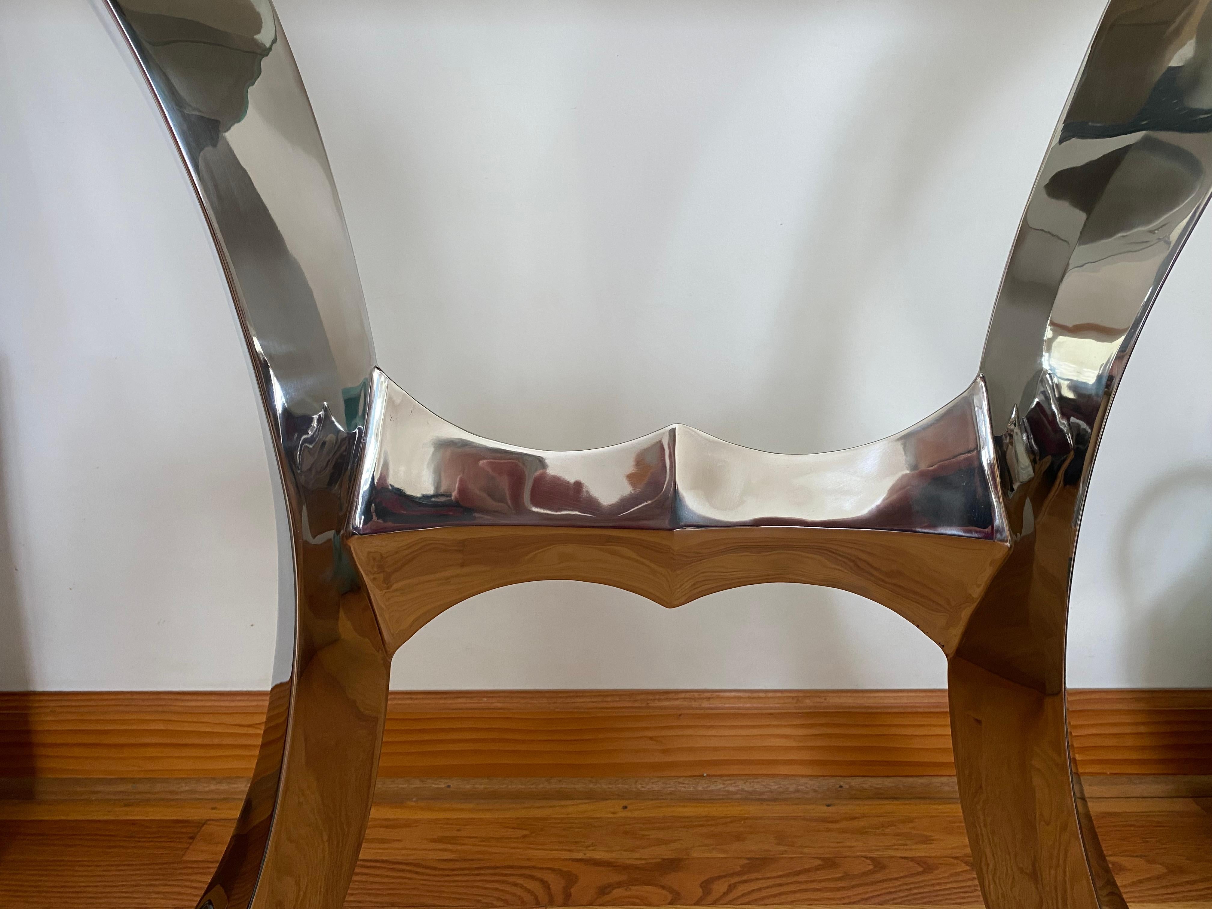This modern console table by Curtis Norton is made from welded and polished stainless steel and has a 1/2