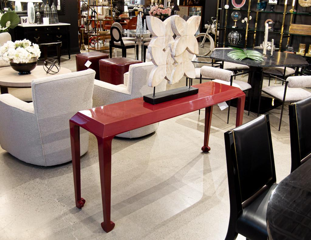 Modern Console Table in Ruby Lacquer Finish. This stunning piece is the perfect combination of style and functionality, making it a must-have for any contemporary home. Crafted with meticulous attention to detail, this console table boasts a unique