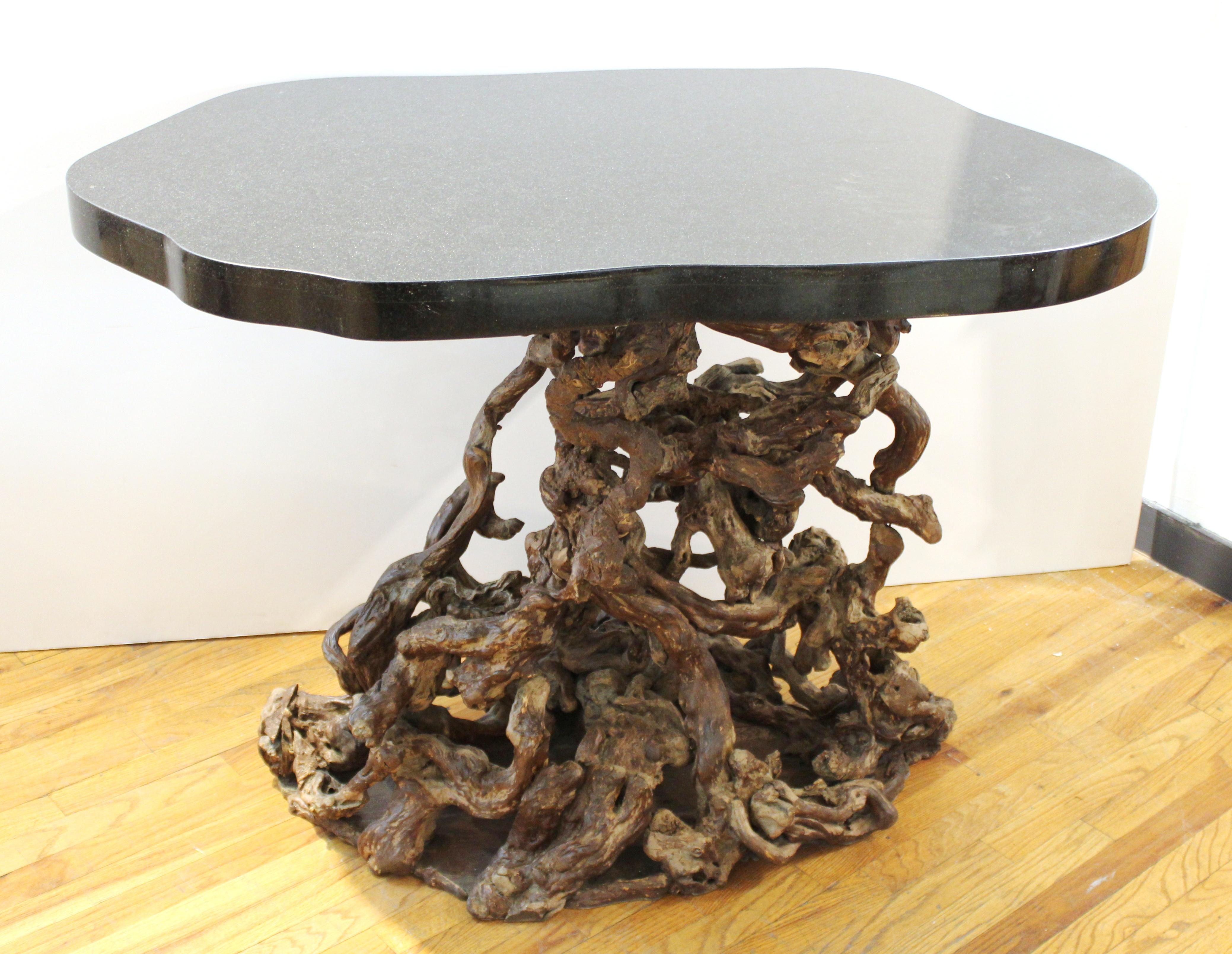 Modern console table or center table with a base made of assembled tree roots and an amorphous heavy stone top.
From a private residence at the Pierre Hotel in New York City.