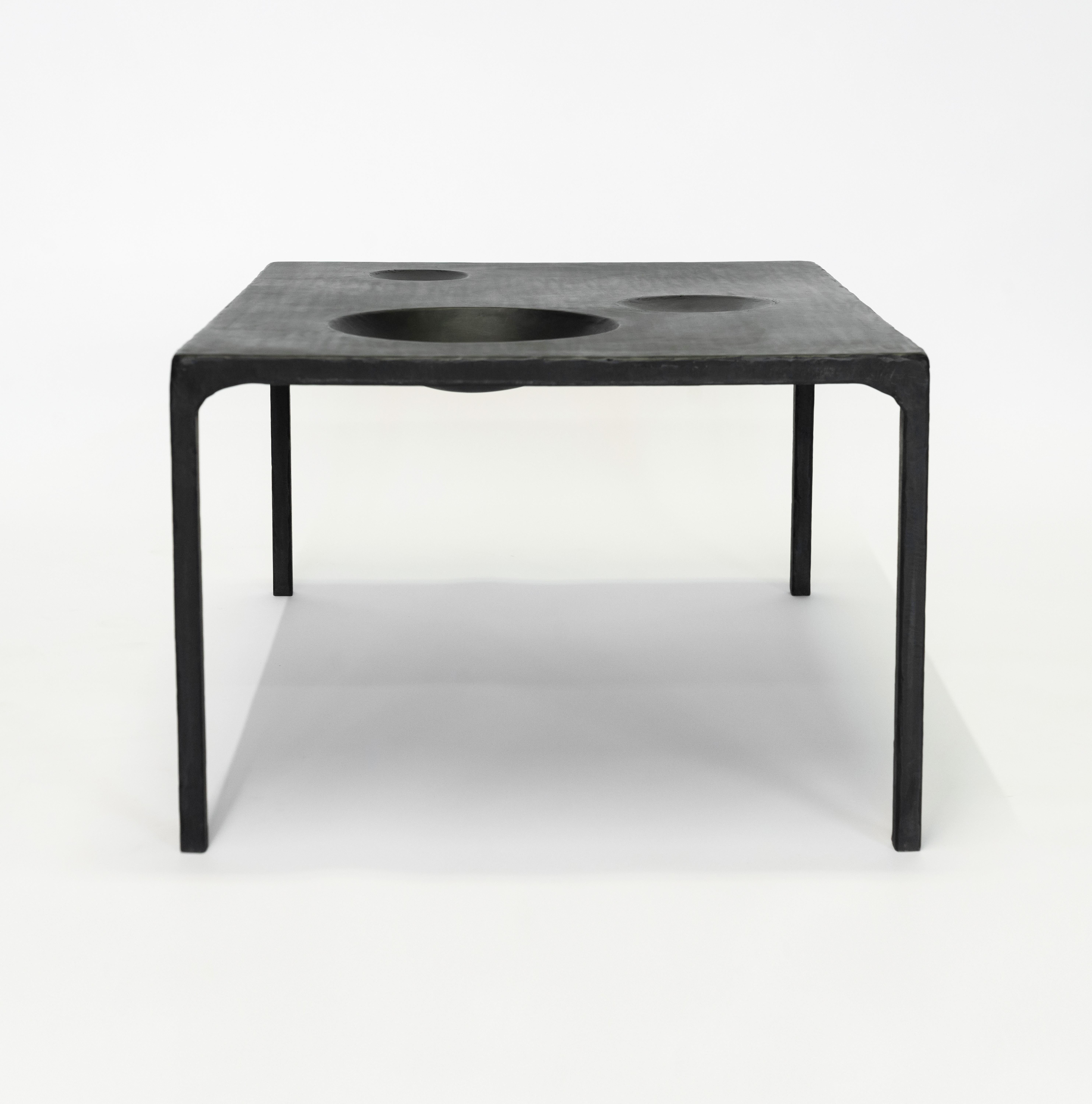 TABLE NO. 11 - SIDE TABLE
J.M. Szymanski
d. 2019
 
Handmade entirely out of blackened and waxed steel, this table features geometric voids within the table itself. Also available with food-safe, ceramic, bowl inserts. Each one is made specifically