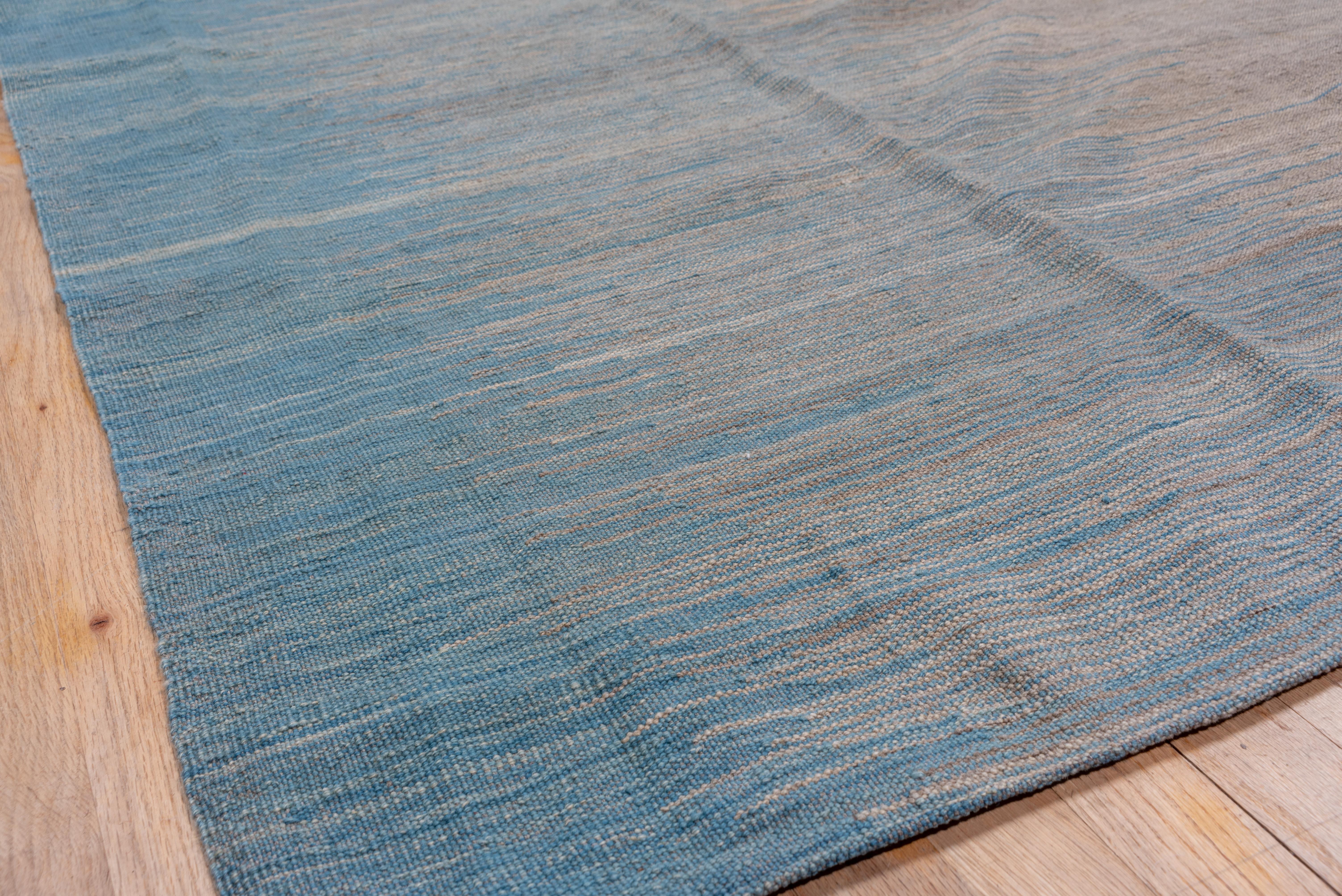 A very simple, and easy handwoven flatweave to place in a room in need of some good cool tones. Blue and gray palette with hints of brown.