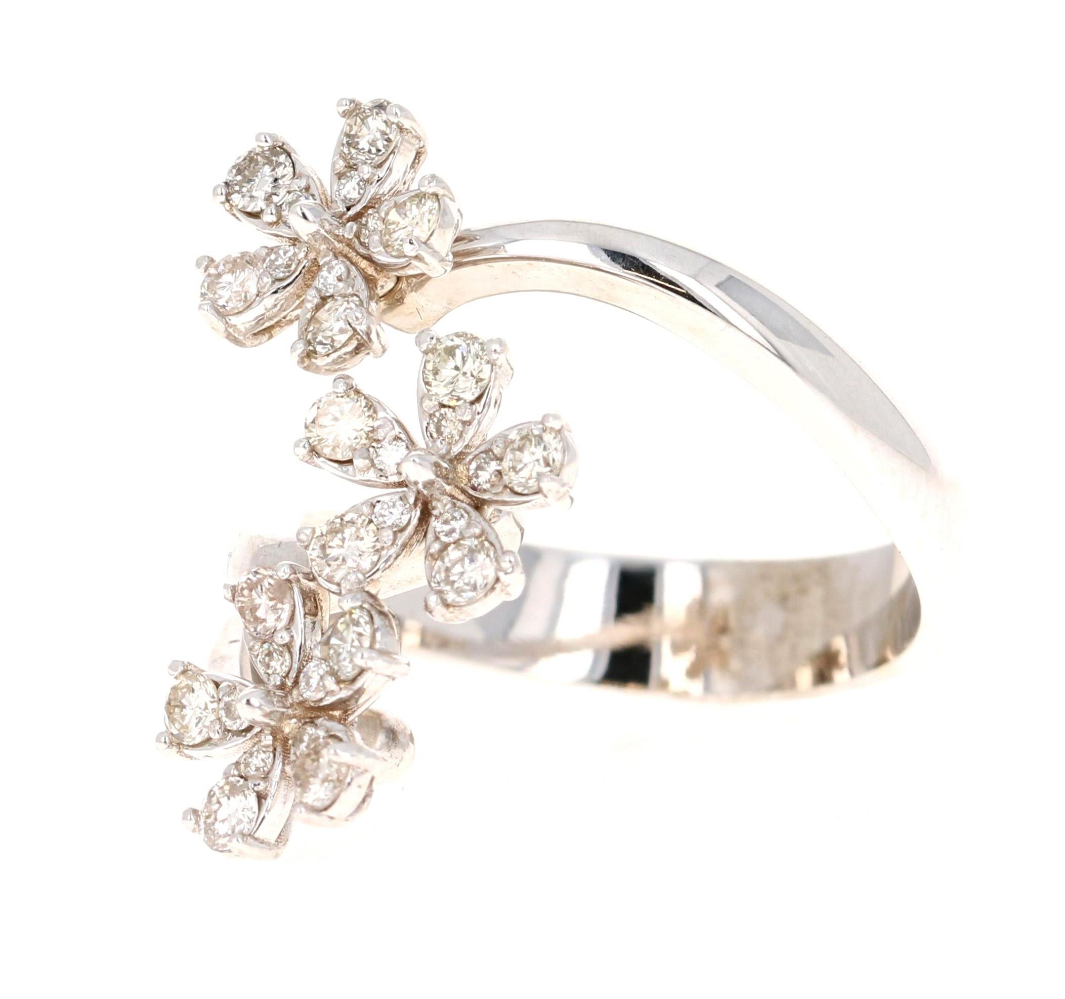 This ring has Natural Diamonds that weigh 0.63 carats and have a clarity and color of SI1-H. The design of the ring is of a group of flowers and are placed elegantly so that it sits elongated on a finger. 

The ring is made in 14 Karat White Gold