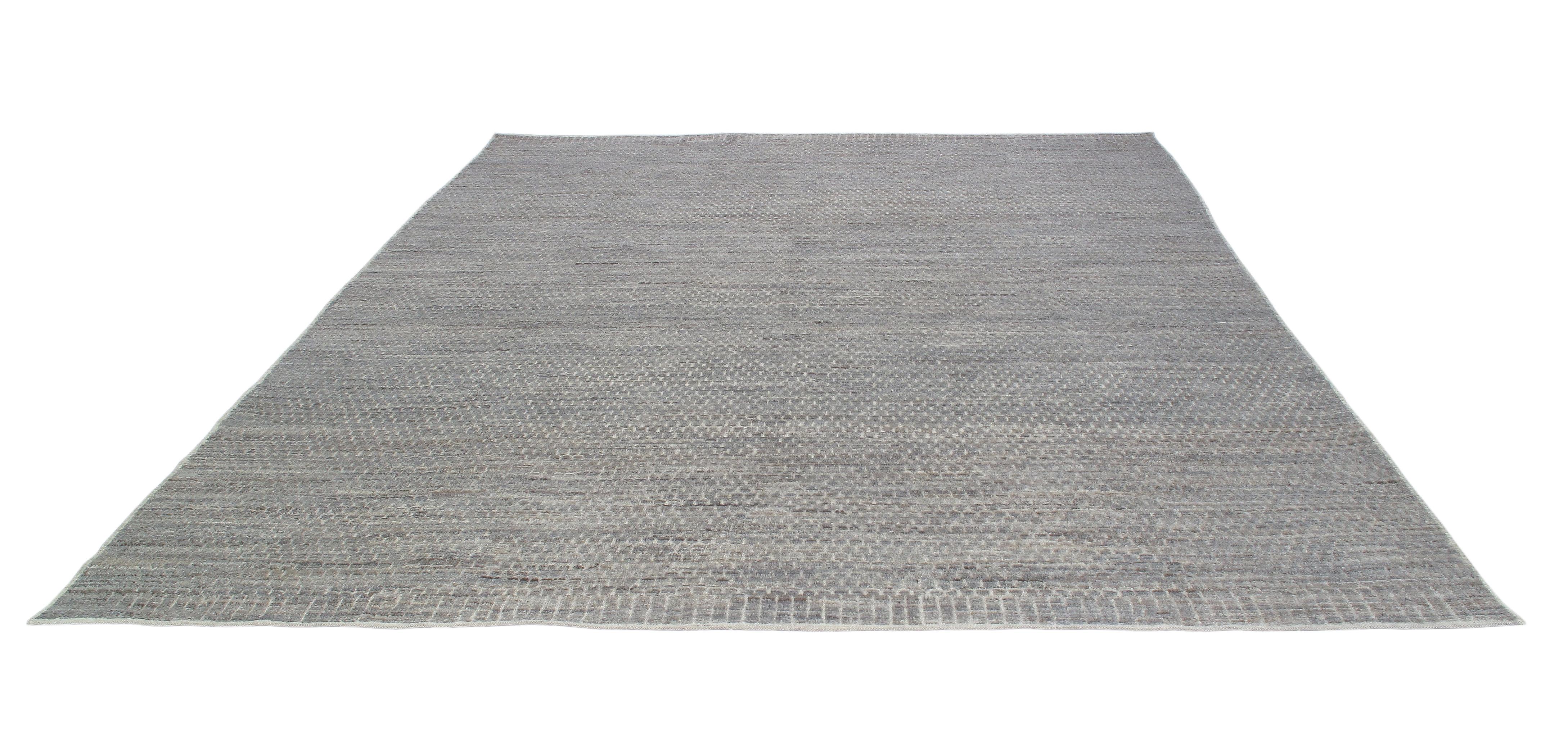 This is a gorgeous relief textural rug.  It is comprised of 100% handspun and handcarded wool.  It has a modern, minimalistic style.  It measures 9'3