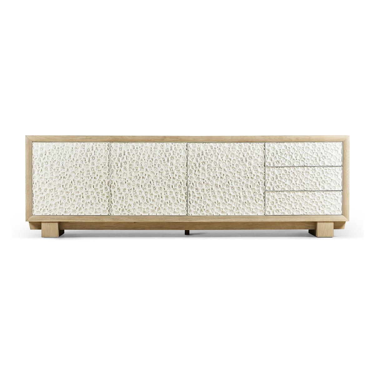 Modern coral media cabinet, inspired by fossilized coral, it boasts an intricate pattern on metal doors produced by lost wax casting. Resting on a hefty linear base, the solid bleached oak case has a primitive and contemporary aesthetic.

Three
