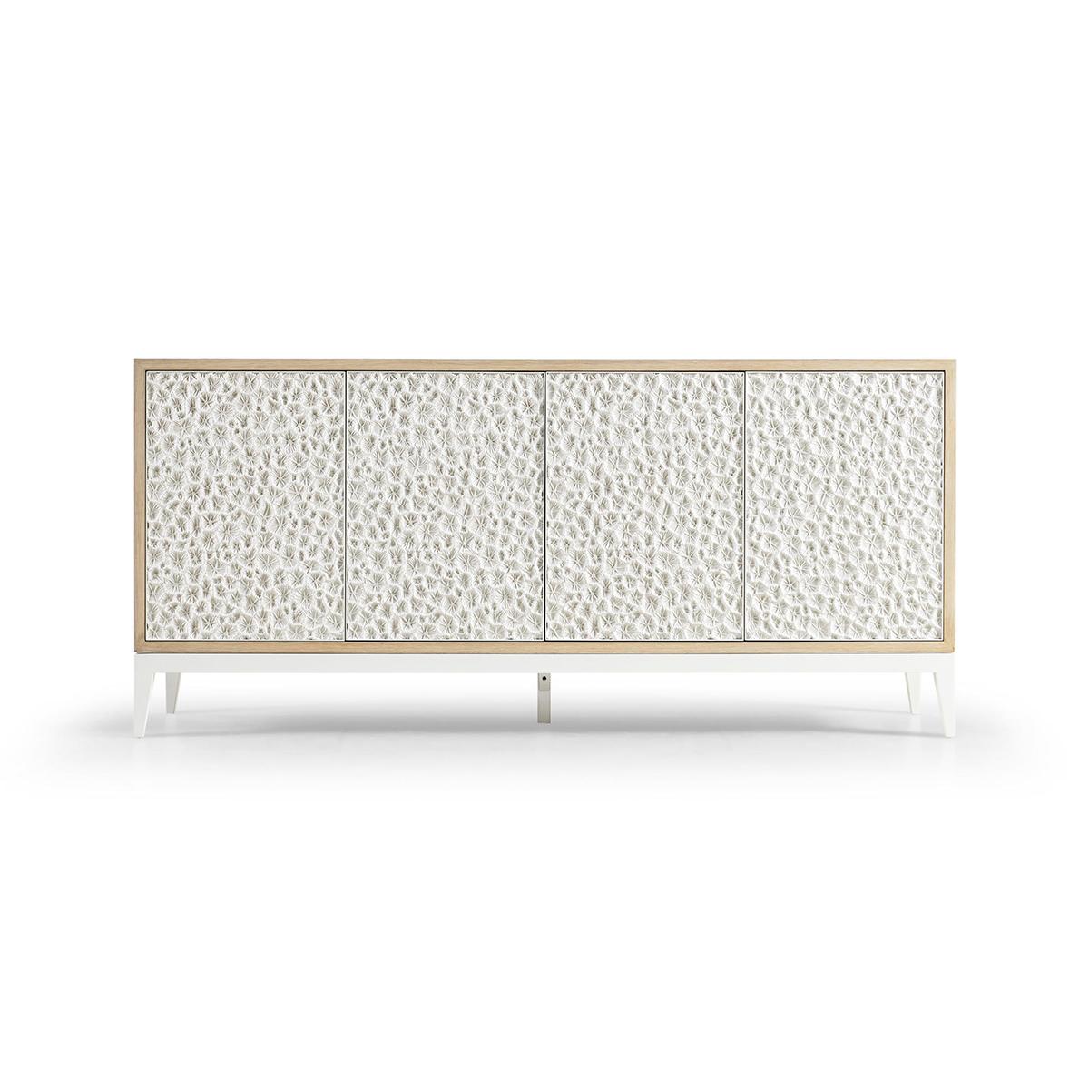 This stunning piece perfectly blends the rustic charm of bleached oak with the intricate beauty of a fossilized coral pattern, meticulously cast in lustrous aluminum.

Equipped with four touch-latch doors that open to reveal ample space, including a