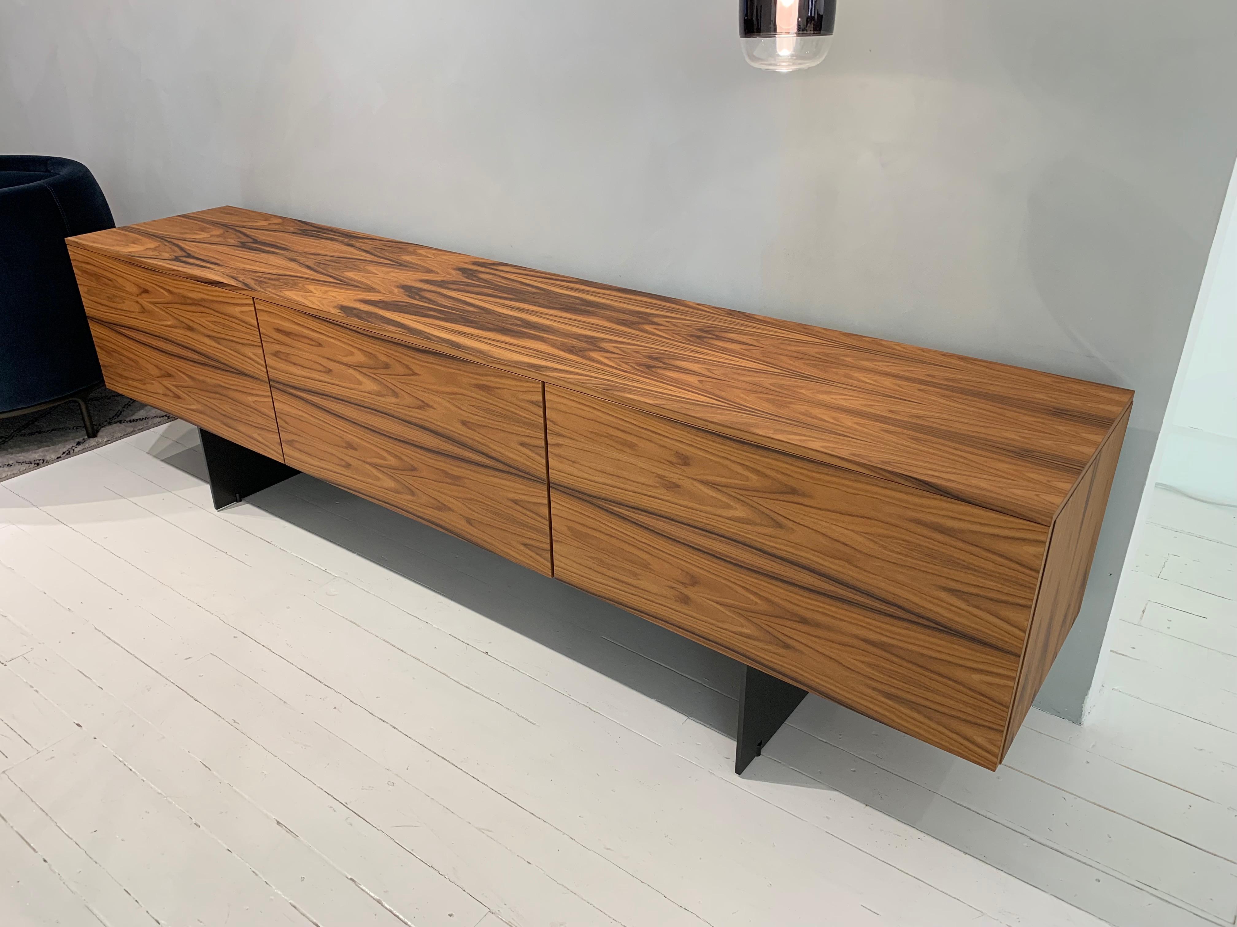 Modern credenza as shown in rosewood with iron base and drop-leaf doors. Simple in aesthetic with plentiful storage room. Designend by Piero Lissoni.

Dimensions: 94.75