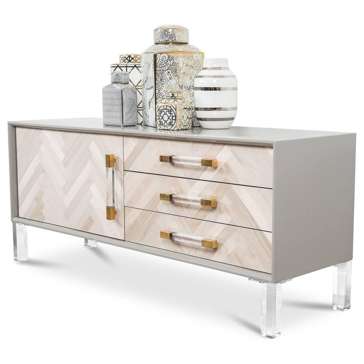 The Amalfi one door three-drawer credenza with its recycled wood doors is perfect for any space. It comes with a graystone case finish, Lucite legs and the walnut wood on the doors create a large herringbone effect.

Dimensions:
60